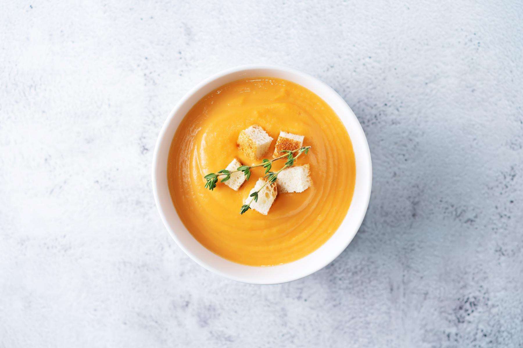Overhead view of a bowl of sweet potato soup.