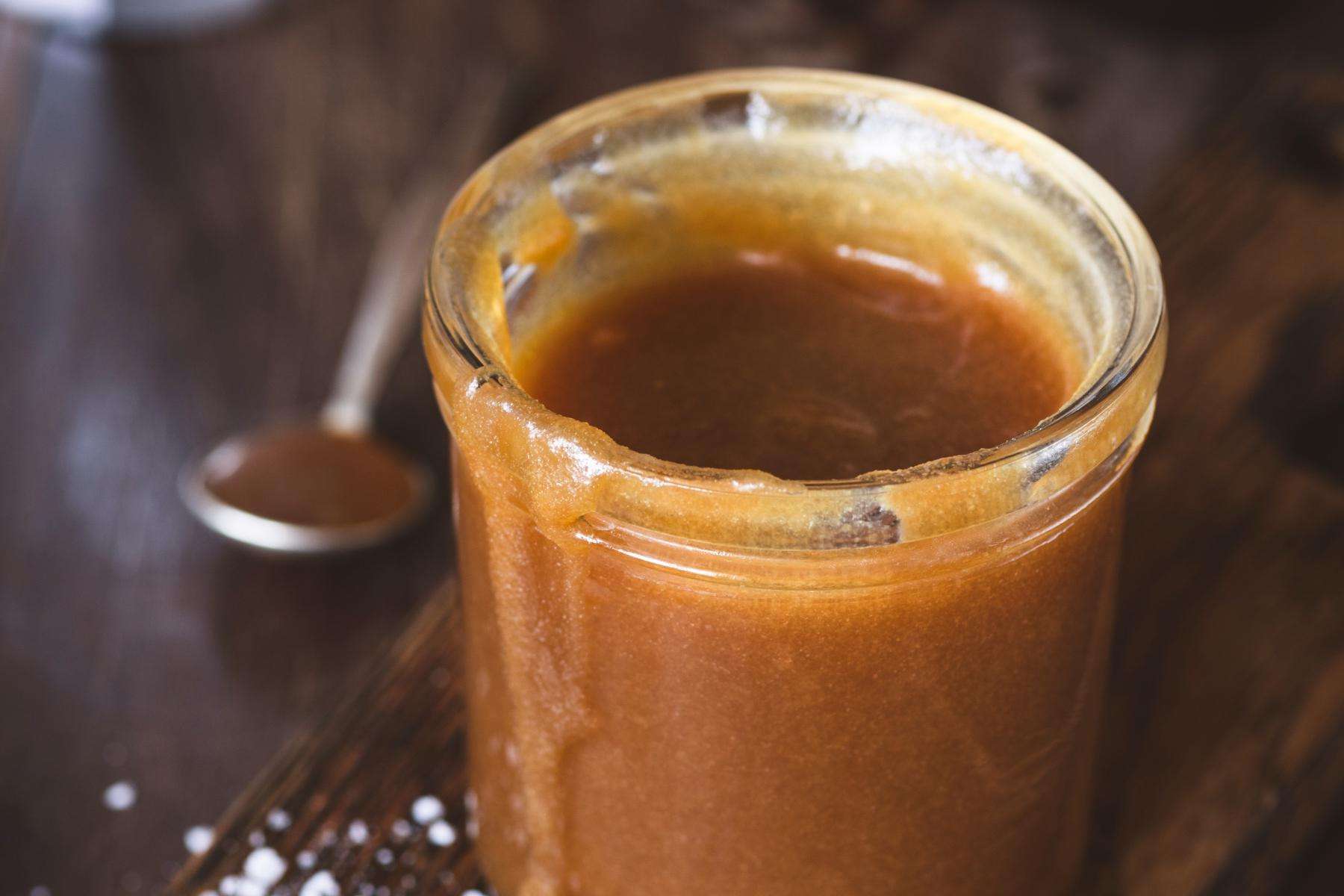 Close-up of a jar of caramel sauce.