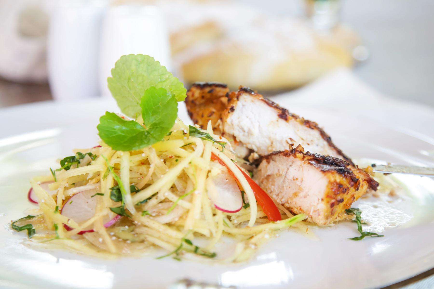 Lemon grass chicken on white plate.