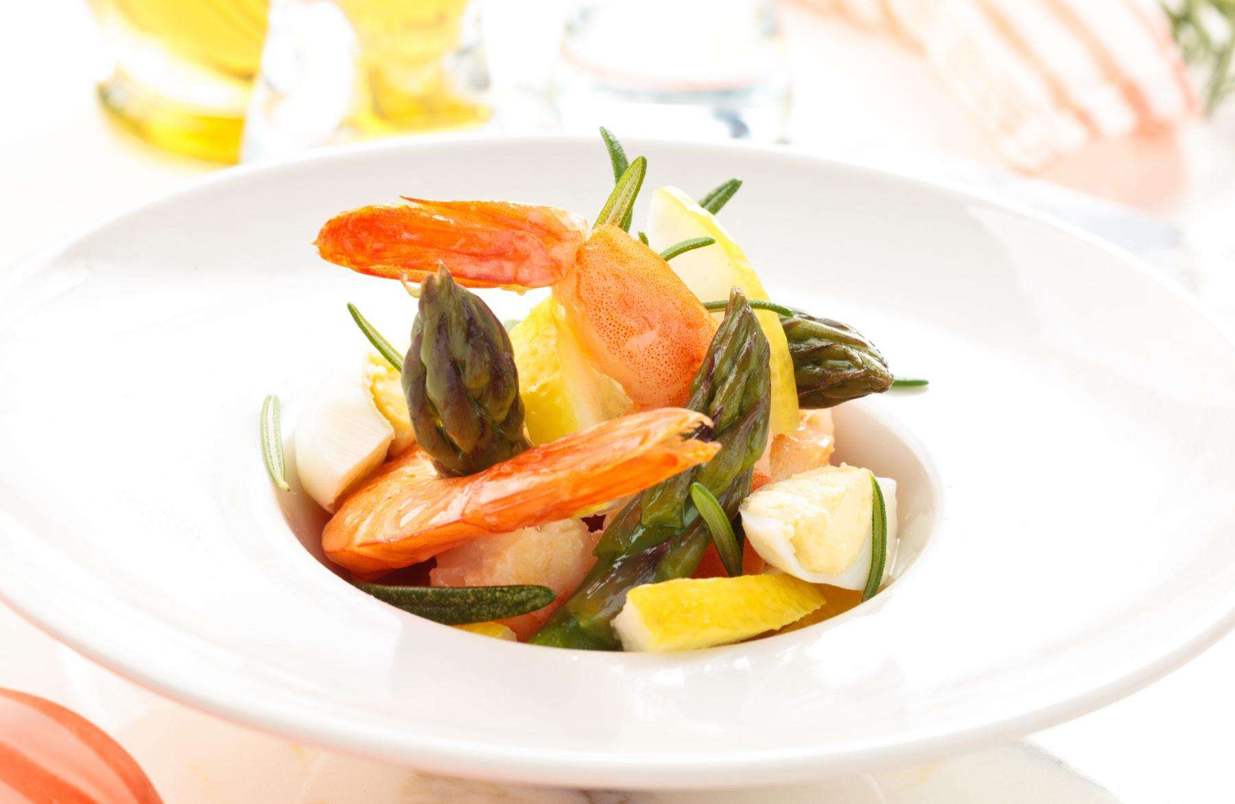 A plate of shrimp salad with mango vinaigrette.