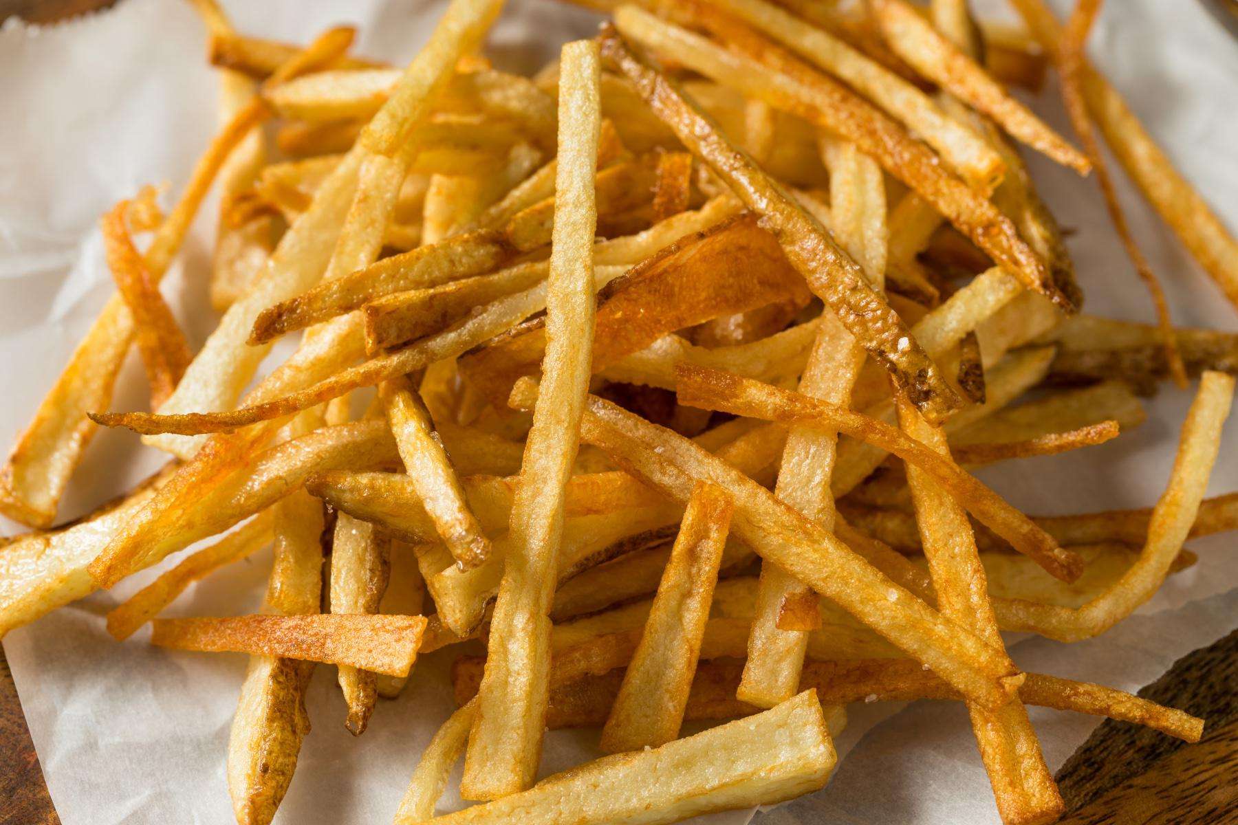 Overhead view of shoestring potato fries on plate.