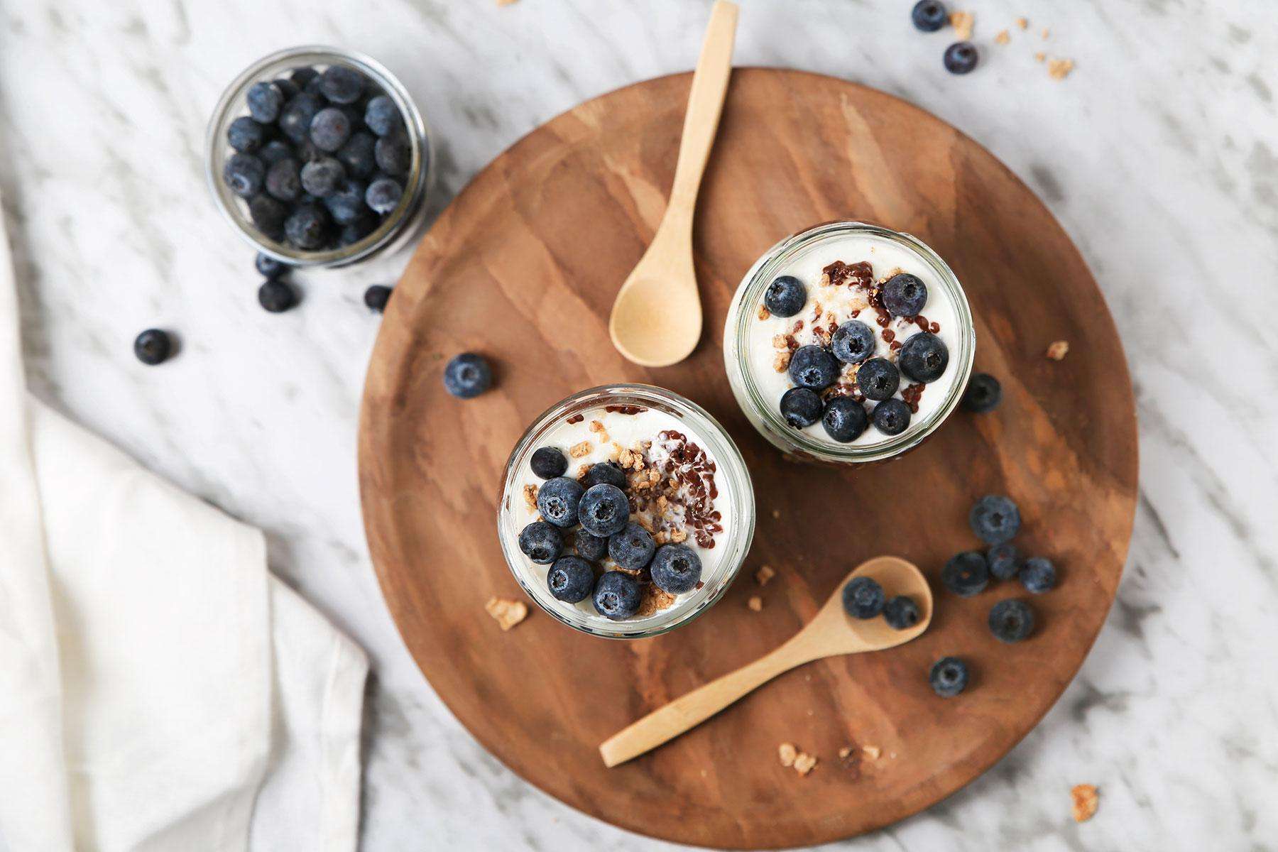 Overhead view off fruit parfaits on wooden serving tray.