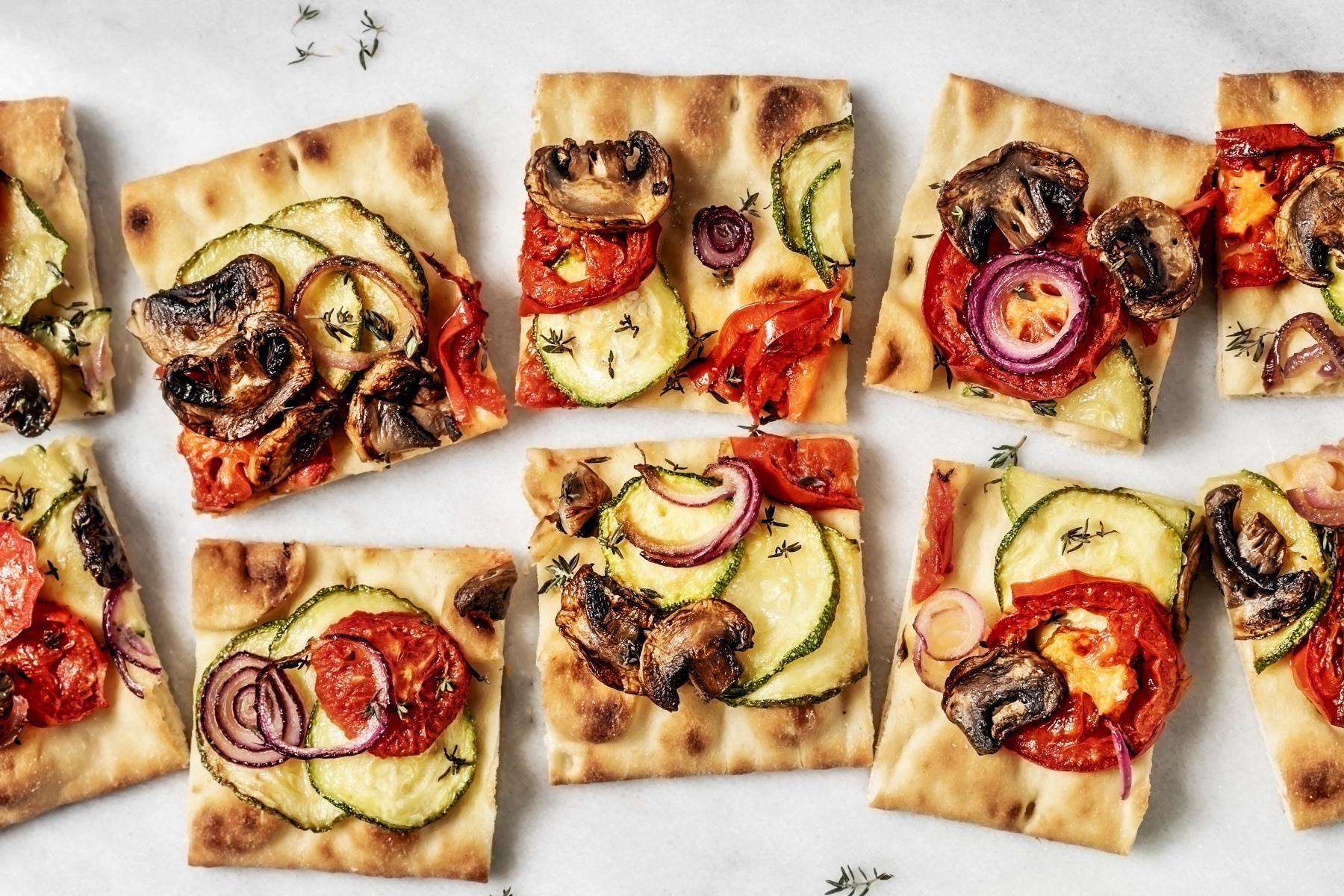 Overhead view of sliced mediterranean flatbreads.