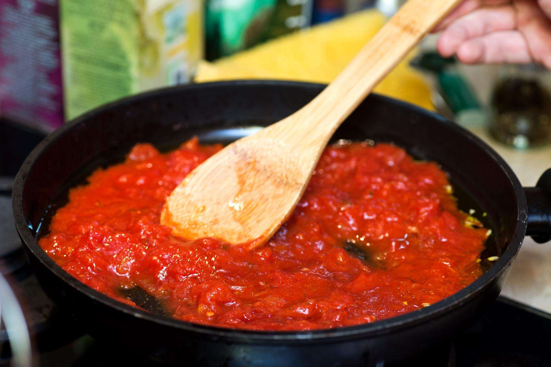 Close-up of cast iron pan filled with vegetable ragu.