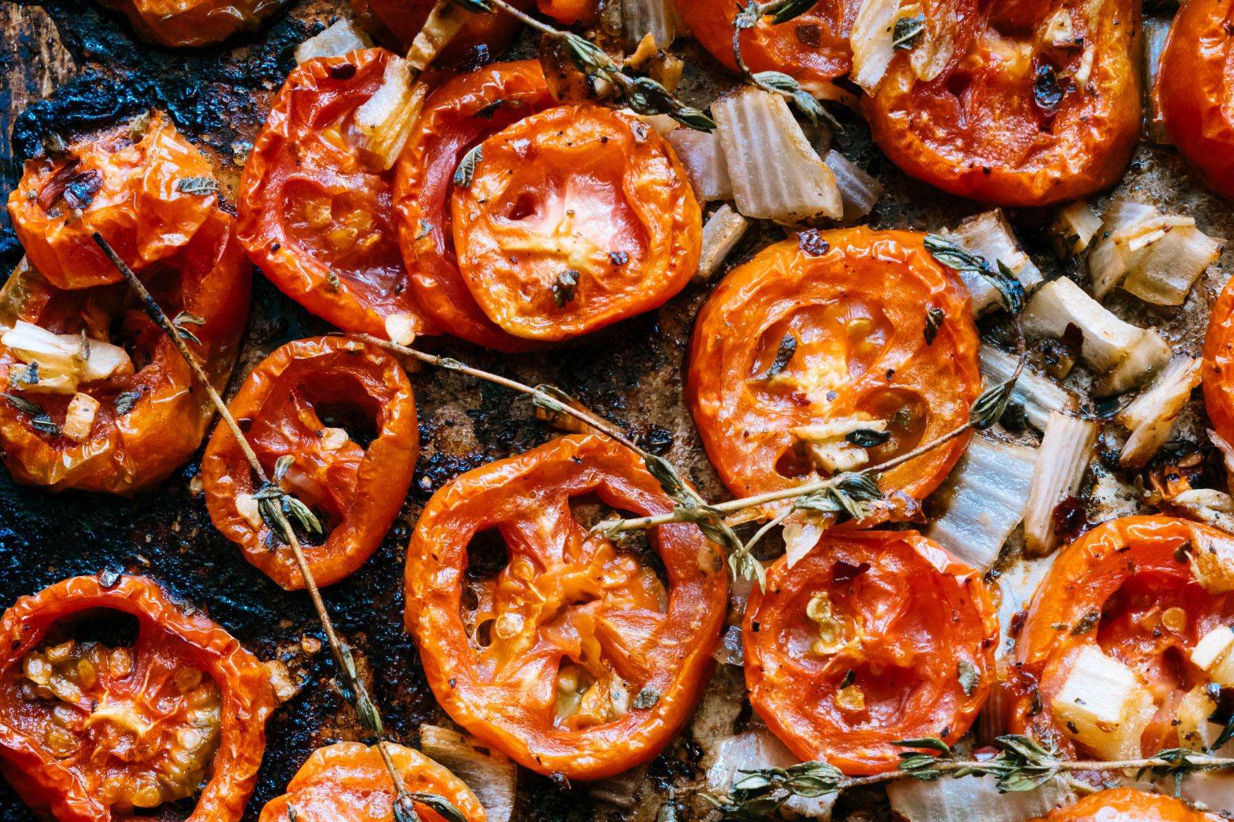 Overhead view of roasted tomatoes on pan.