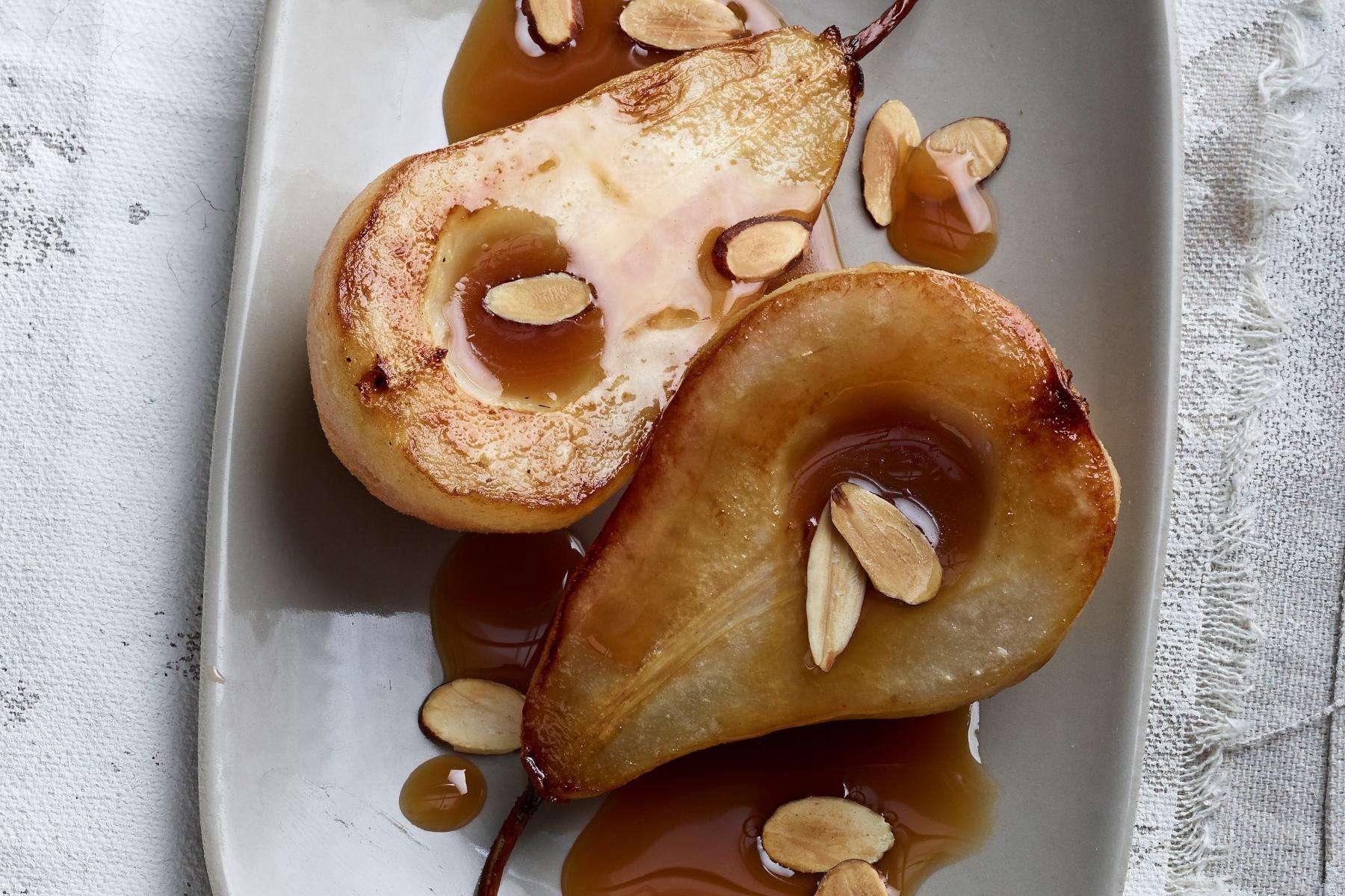 Overhead view of simmered pears cut in half.