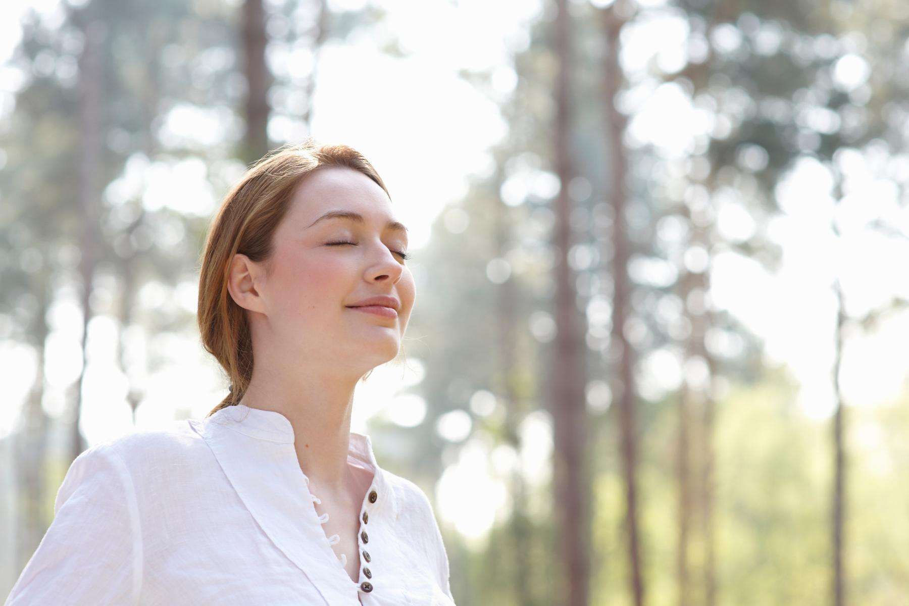 Close-up of man sitting on couch leaning back with eyes closed.
