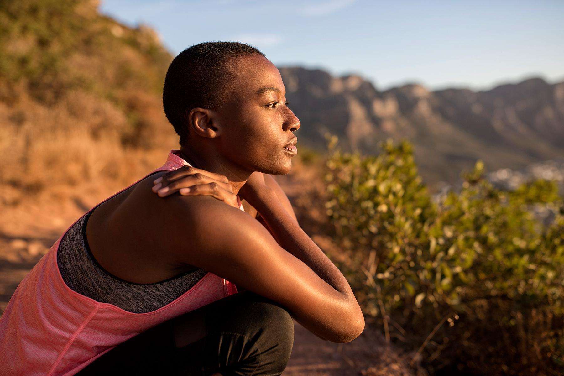 A woman on a hike taking a moment to take in the scenery.