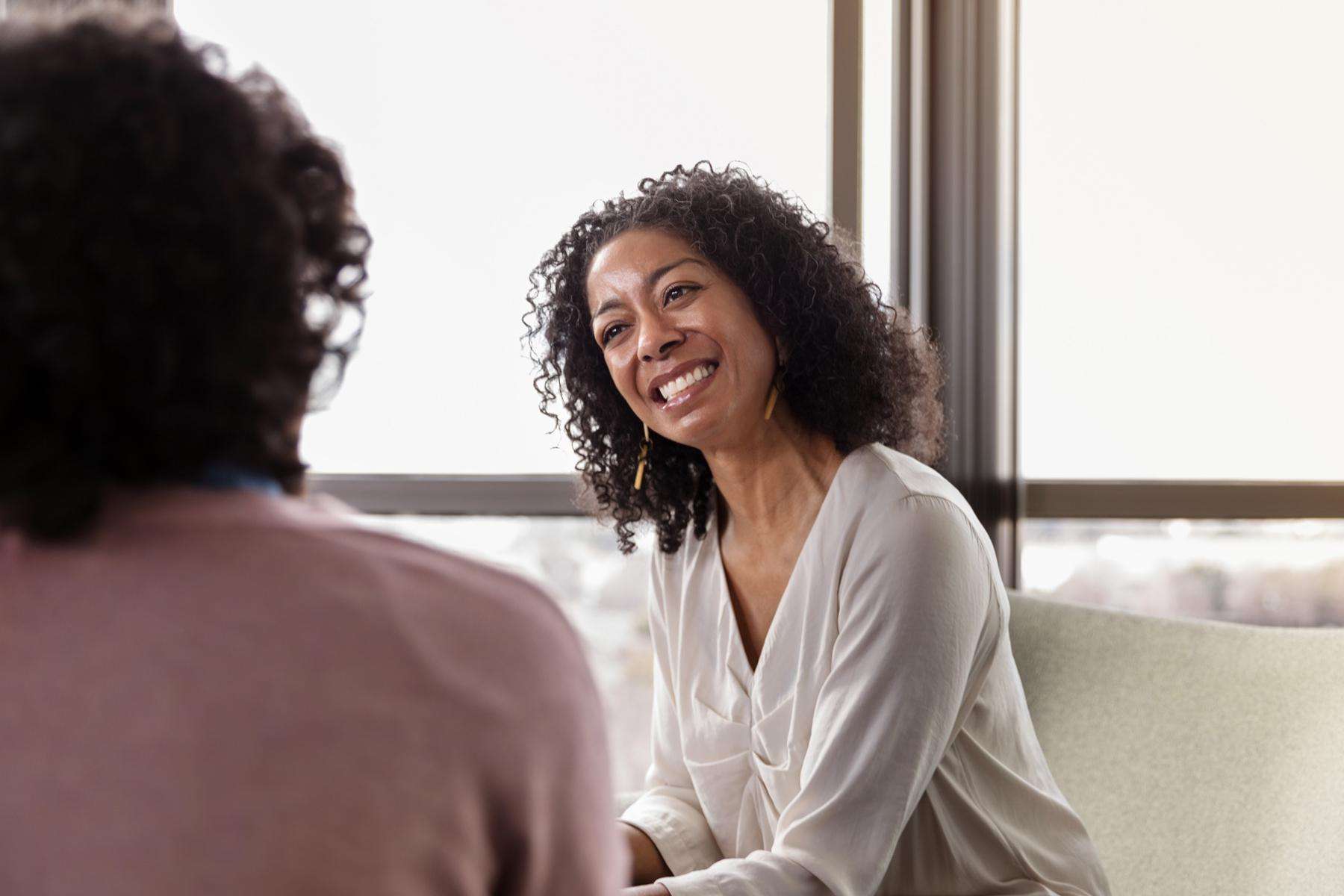 A spiritual counselor smiling at her client.