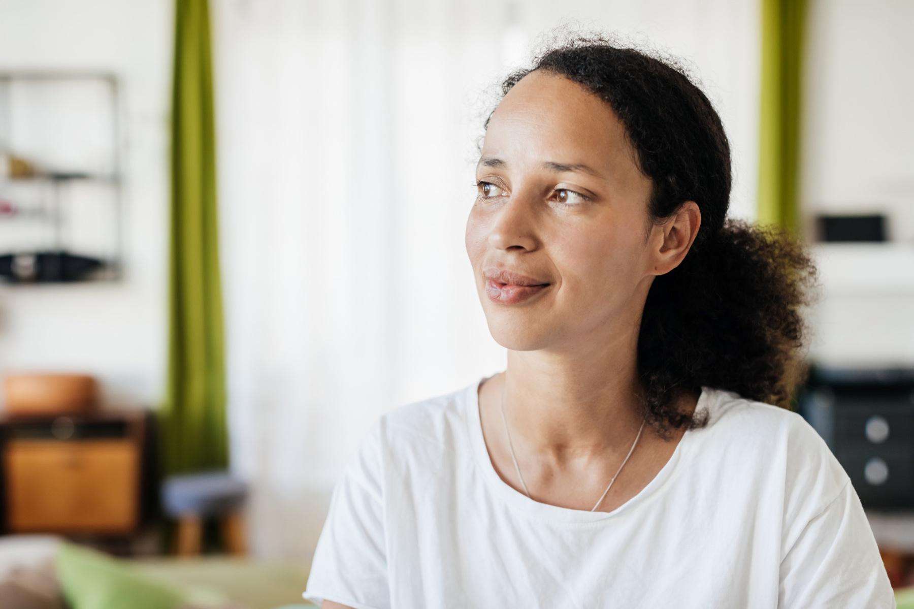 Woman looking off to the side with a slight smile.