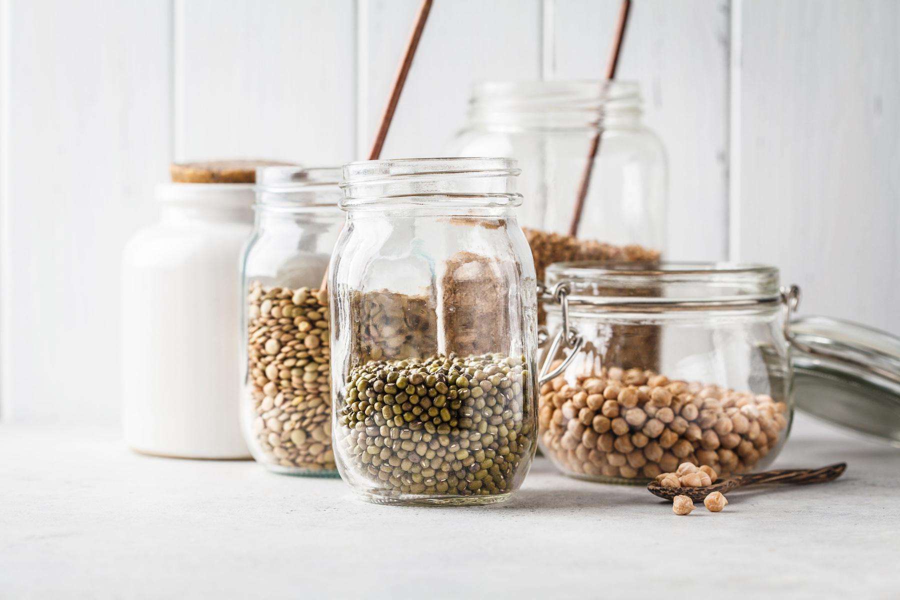 close-up of dry pantry goods including beans in mason jars