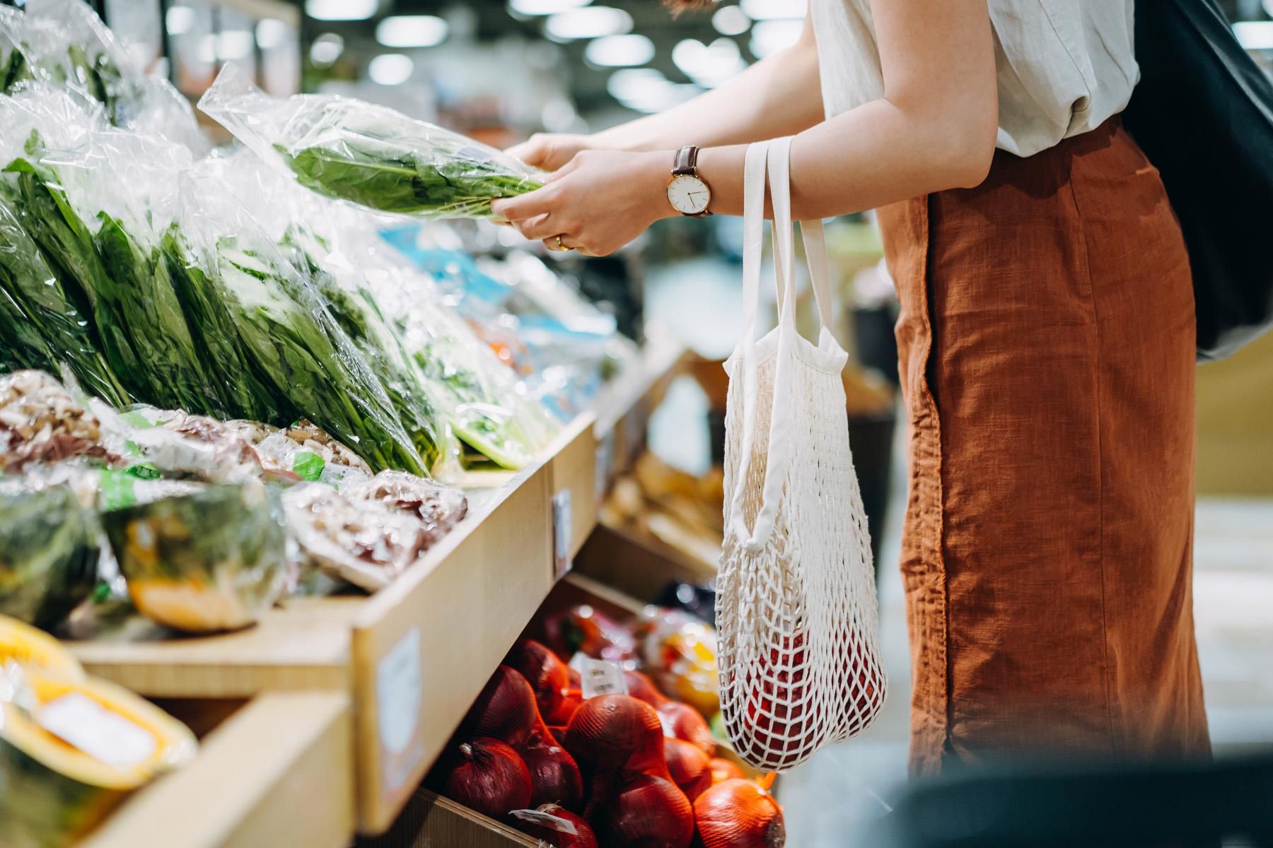 Image of woman grocery shopping for vegetables.