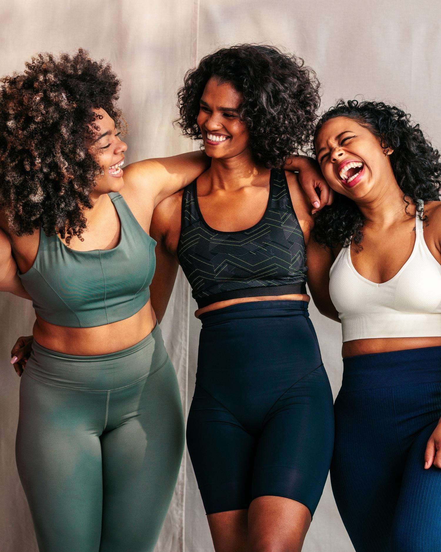 a group of three women laughing