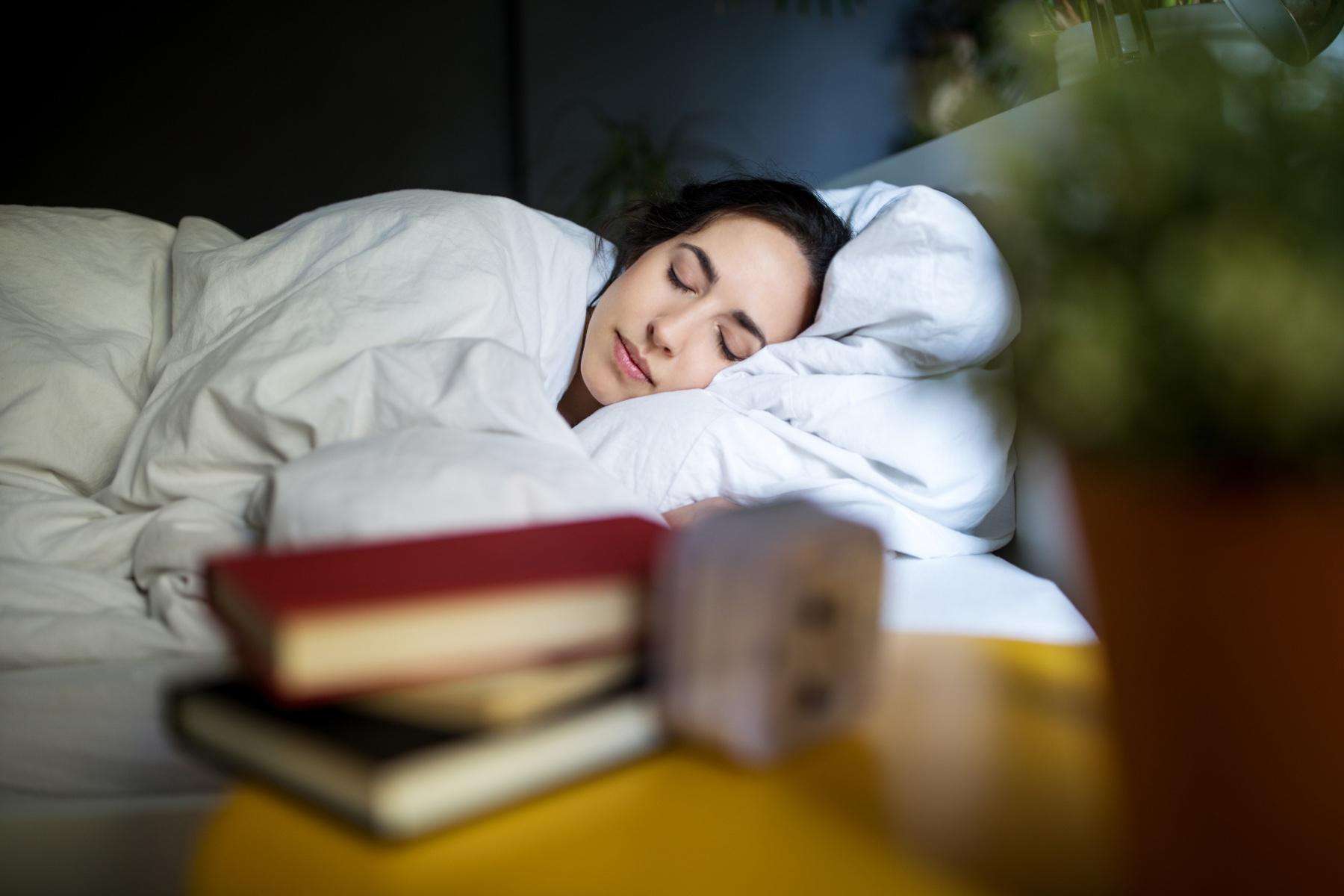 Close-up of woman's face as she lays in bed on her side.