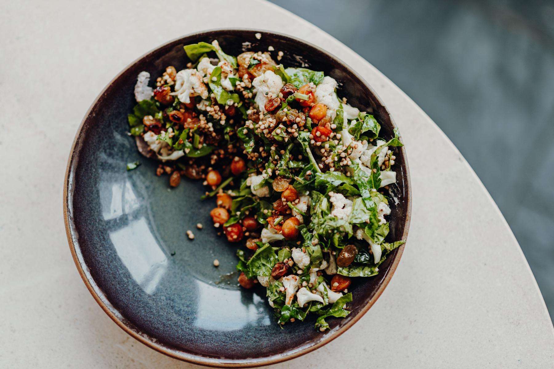 Close overhead shot of blue bowl with healthy salad.
