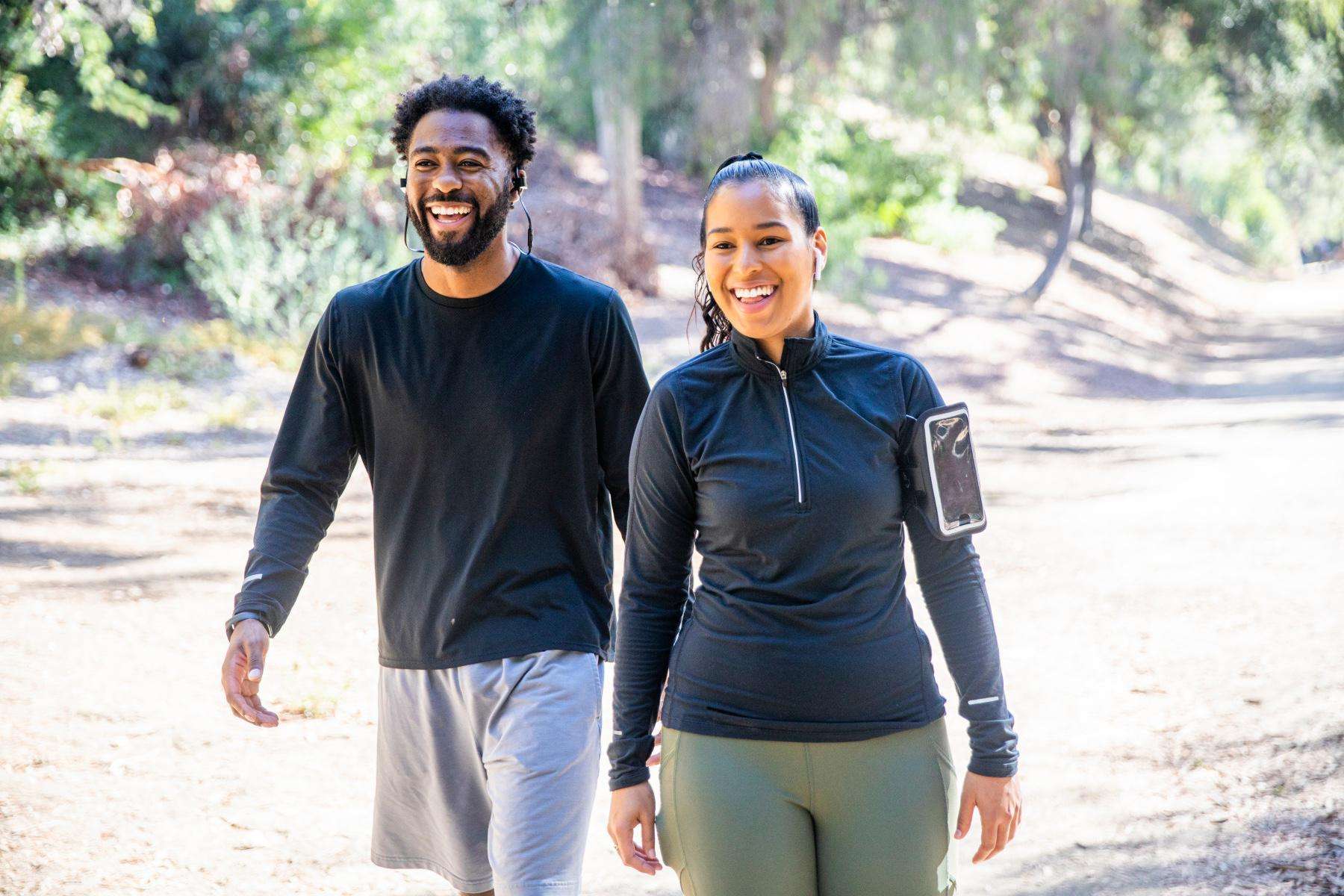 young, smiling, couple in workout clothes walking together on a path in Tucson, Arizona