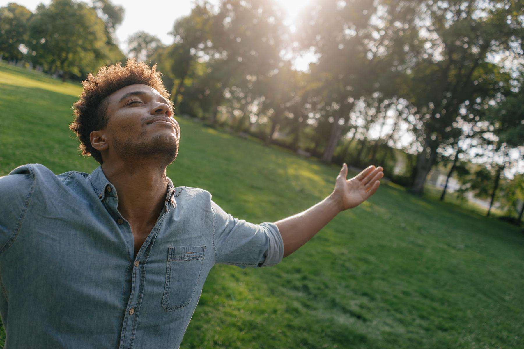 Man with his arms outstretched towards the sky.