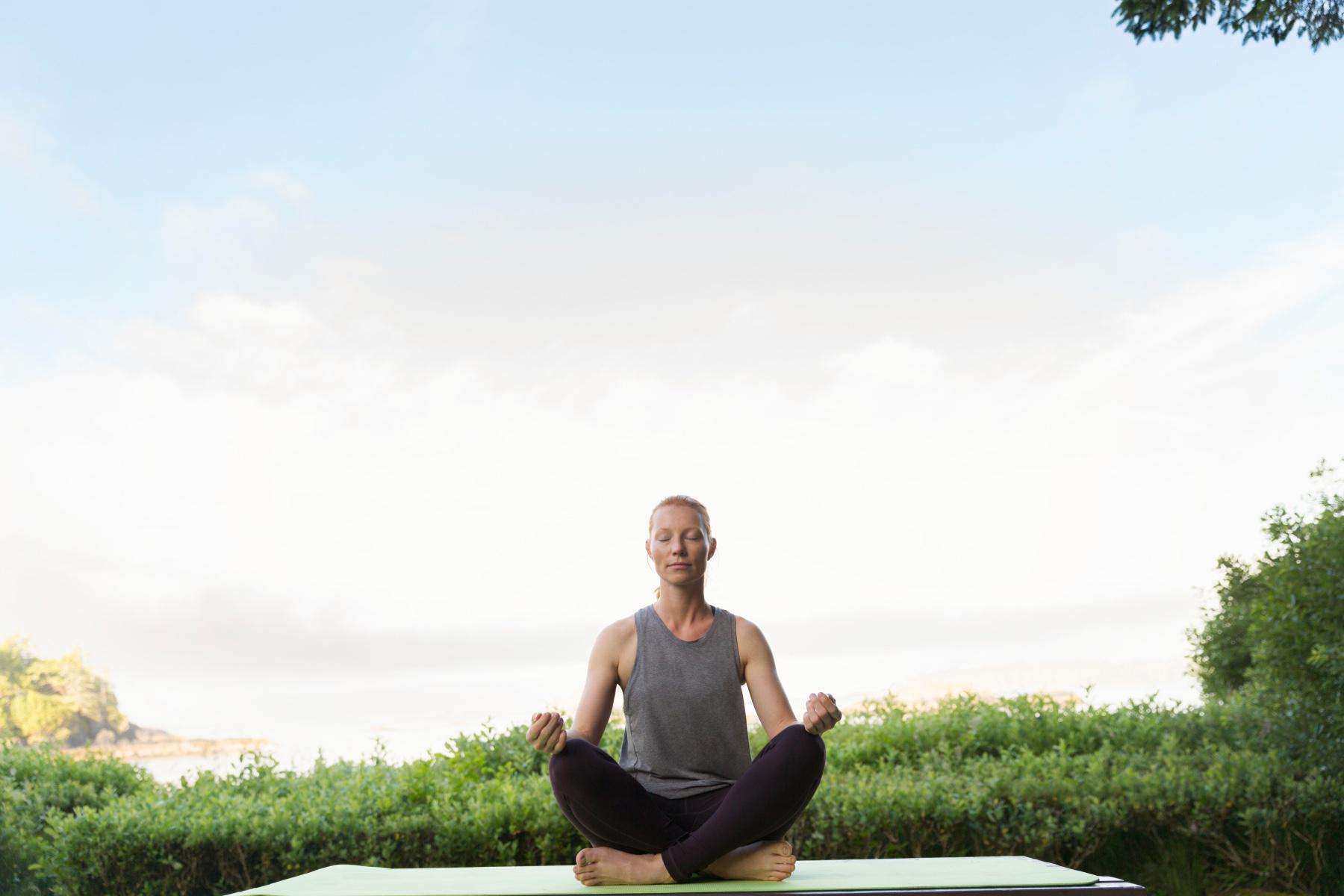 Woman meditating in a park.