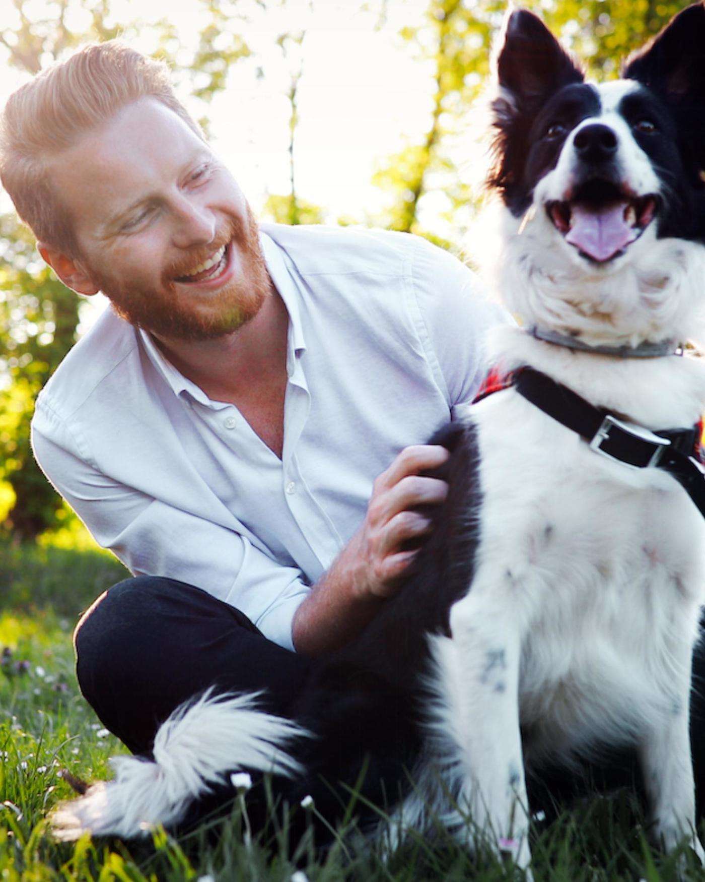 A Man with a border collie in the sunshine