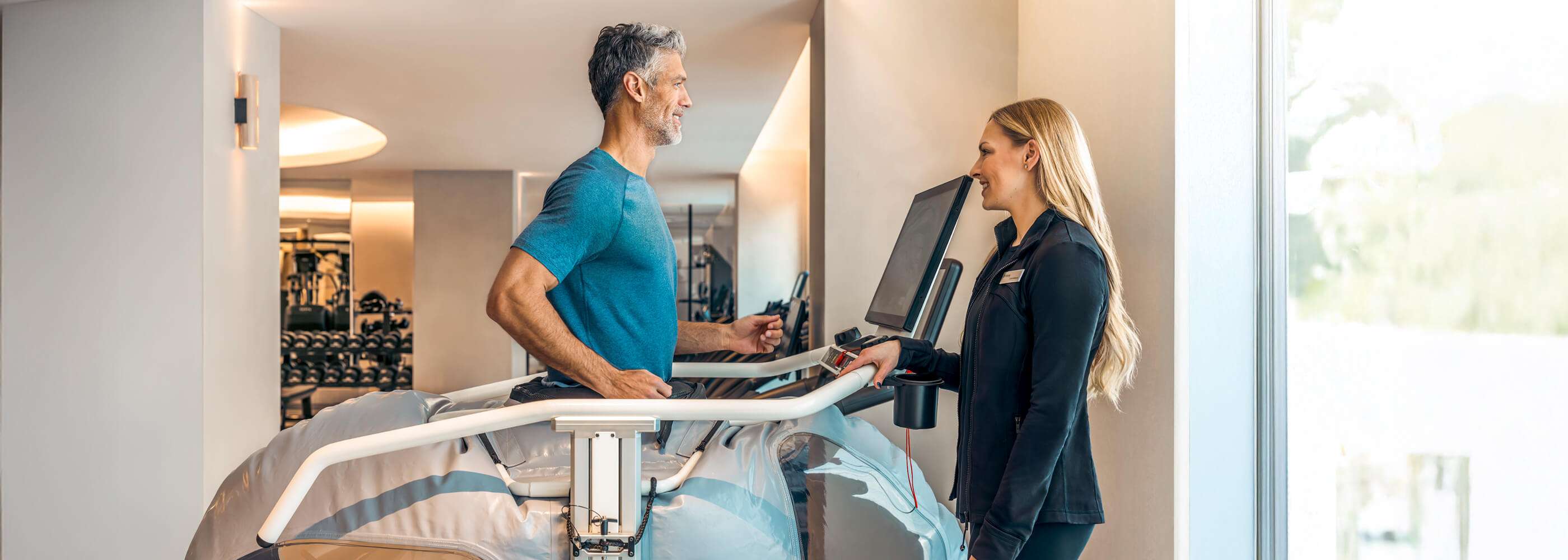 A man on a treadmill with a performance scientist