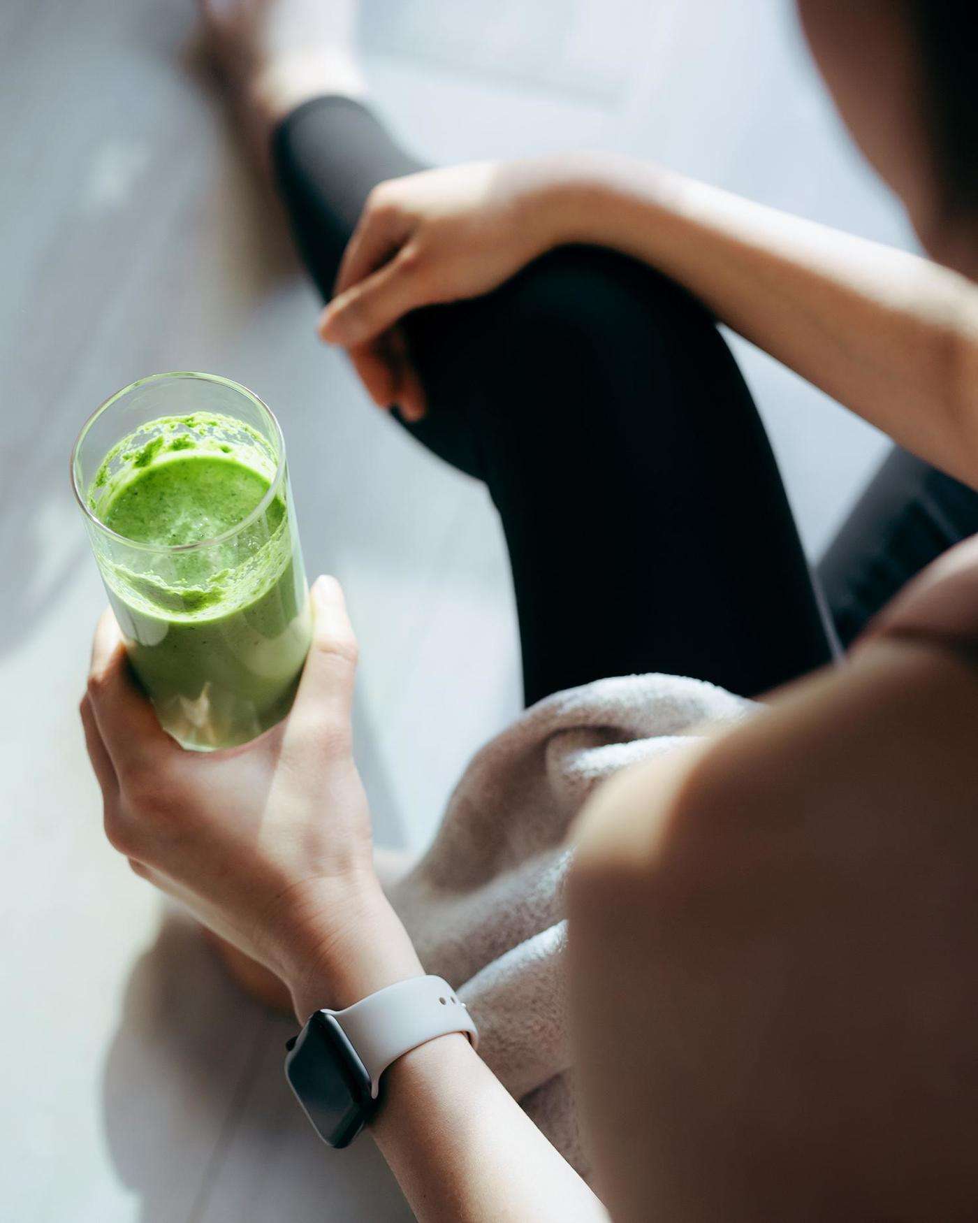 A woman drinking a smoothie
