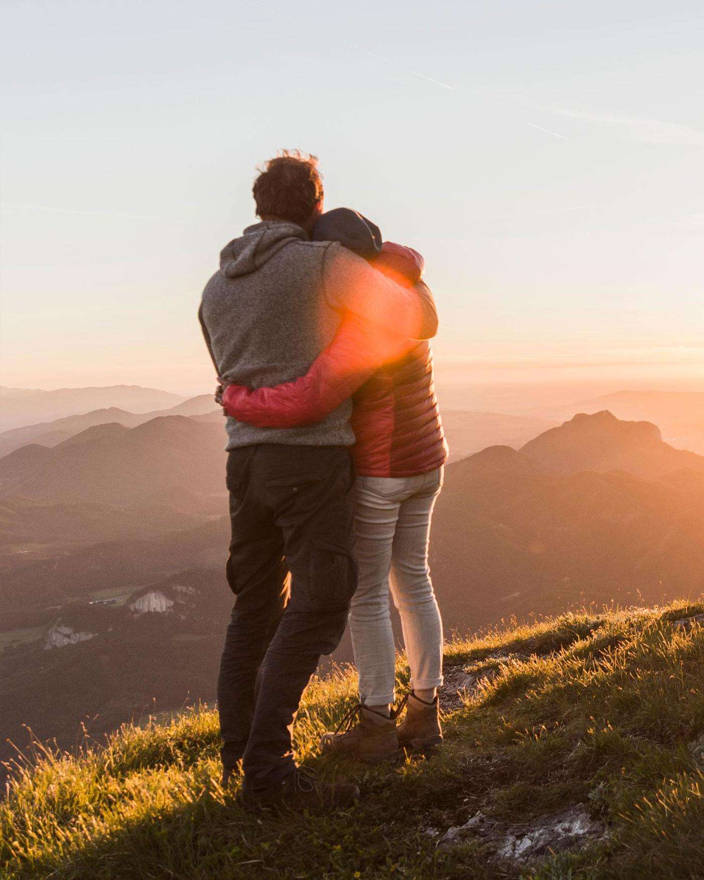 A man and woman watching a sunset
