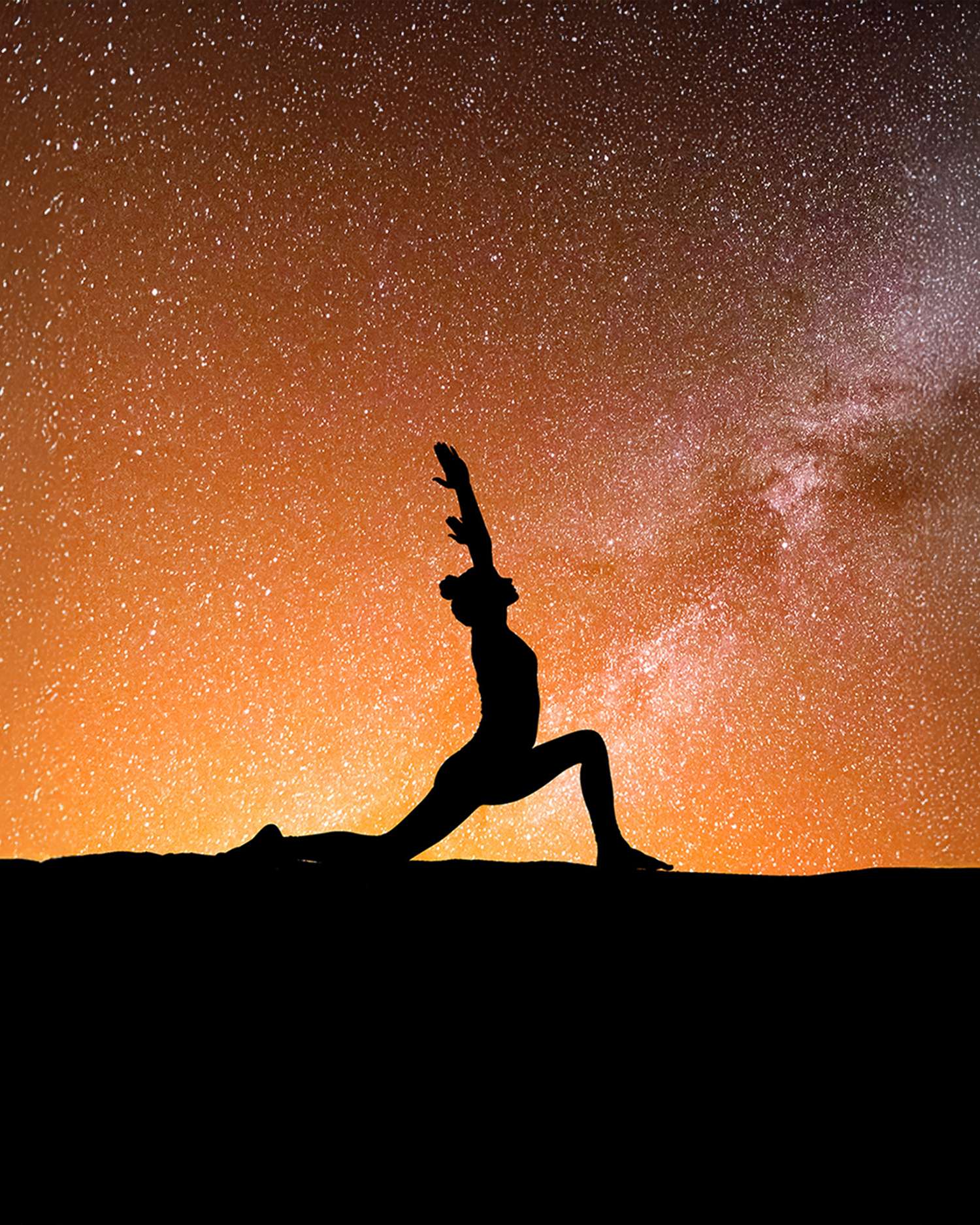 A woman doing yoga under the stars