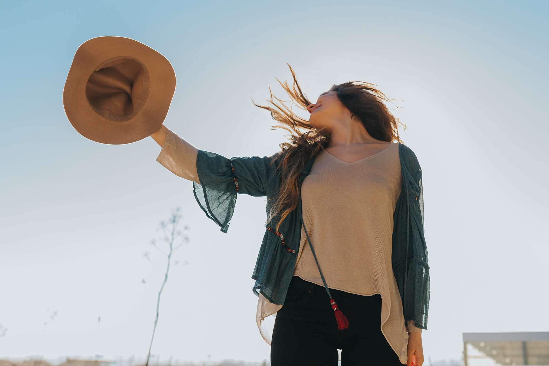 a girl throwing a cowboy hat