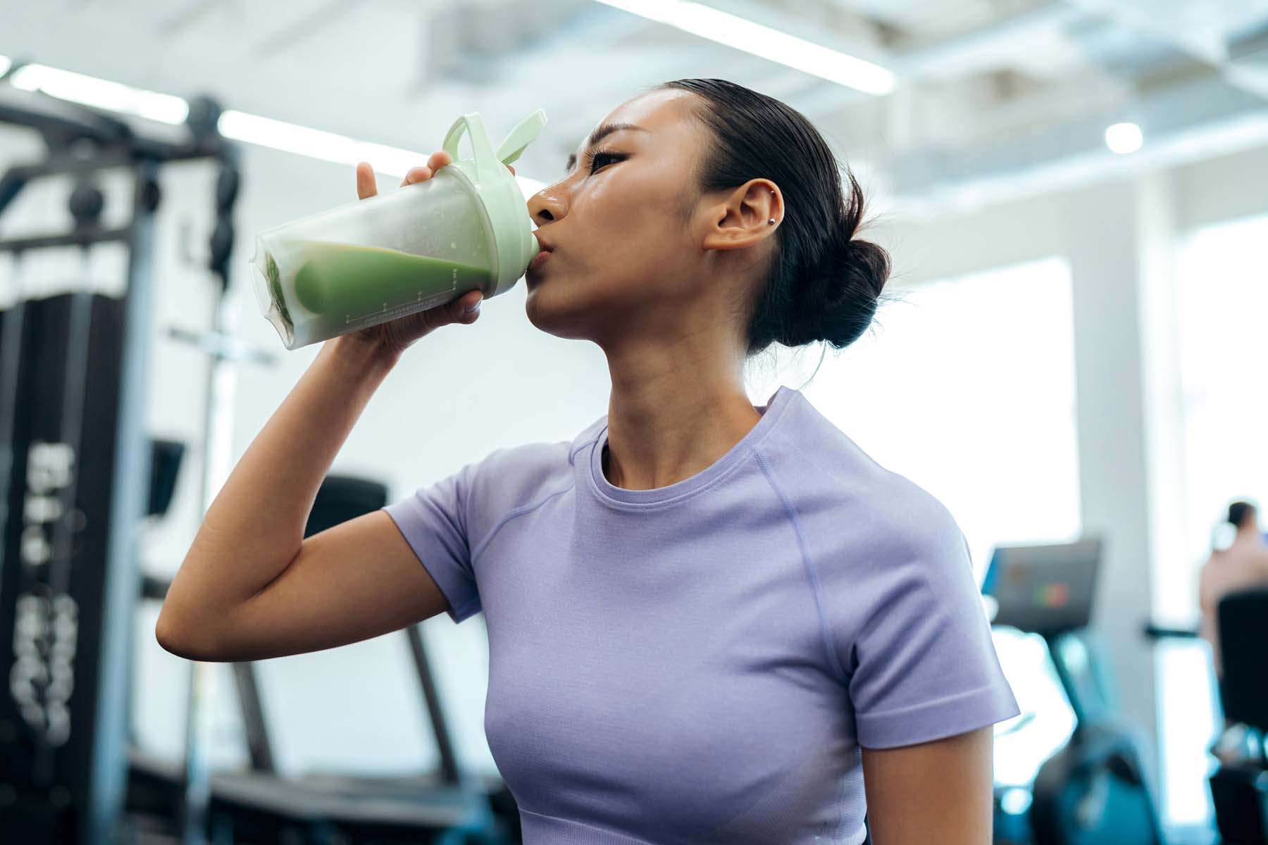 a woman drinking a smoothie