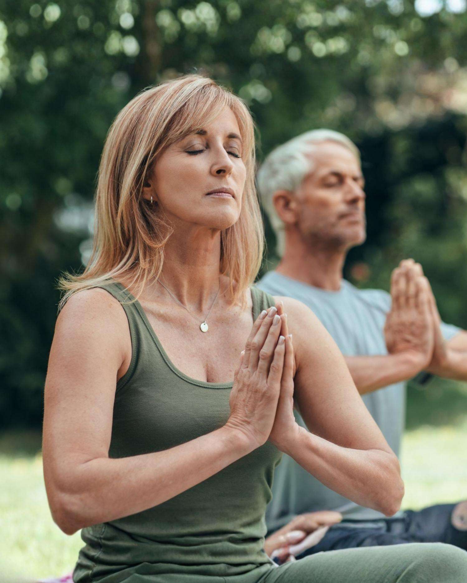 A couple meditating outdoors in Lenox