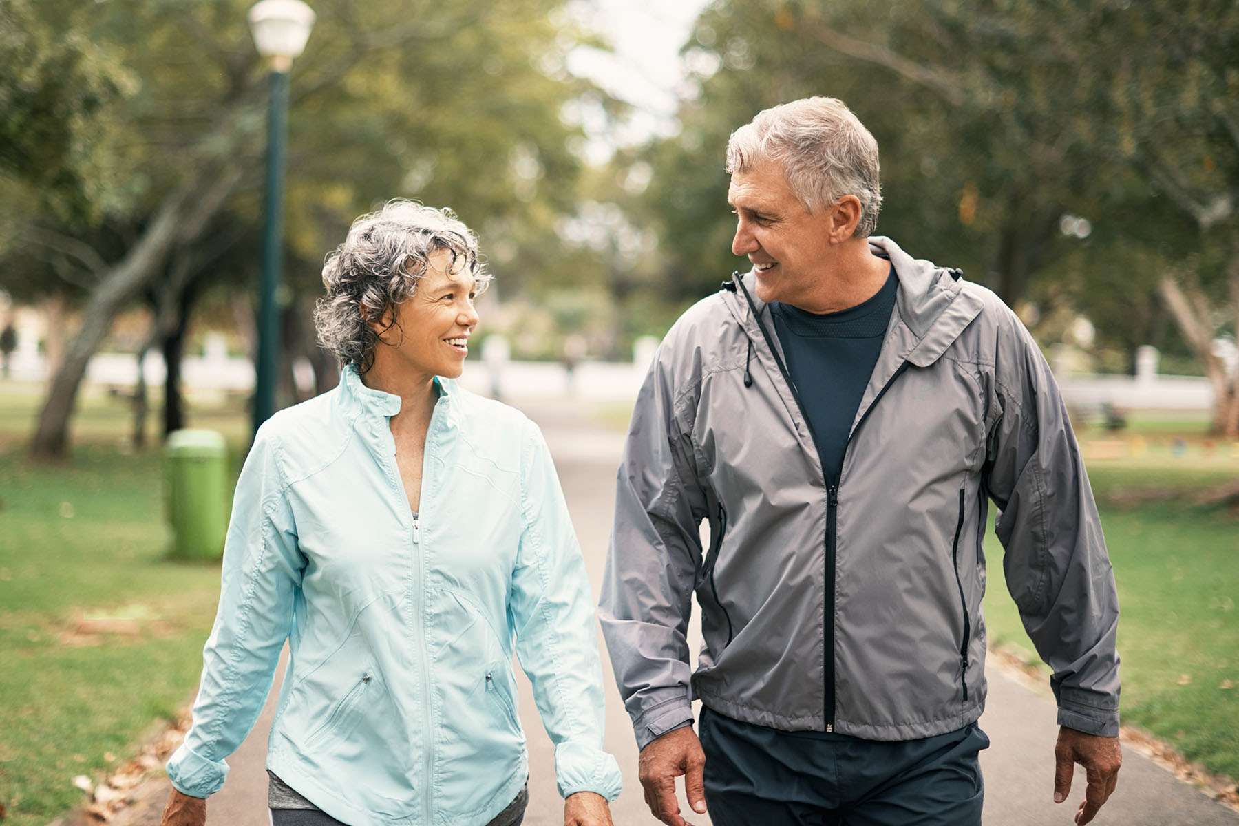 A man and woman walking together laughing.