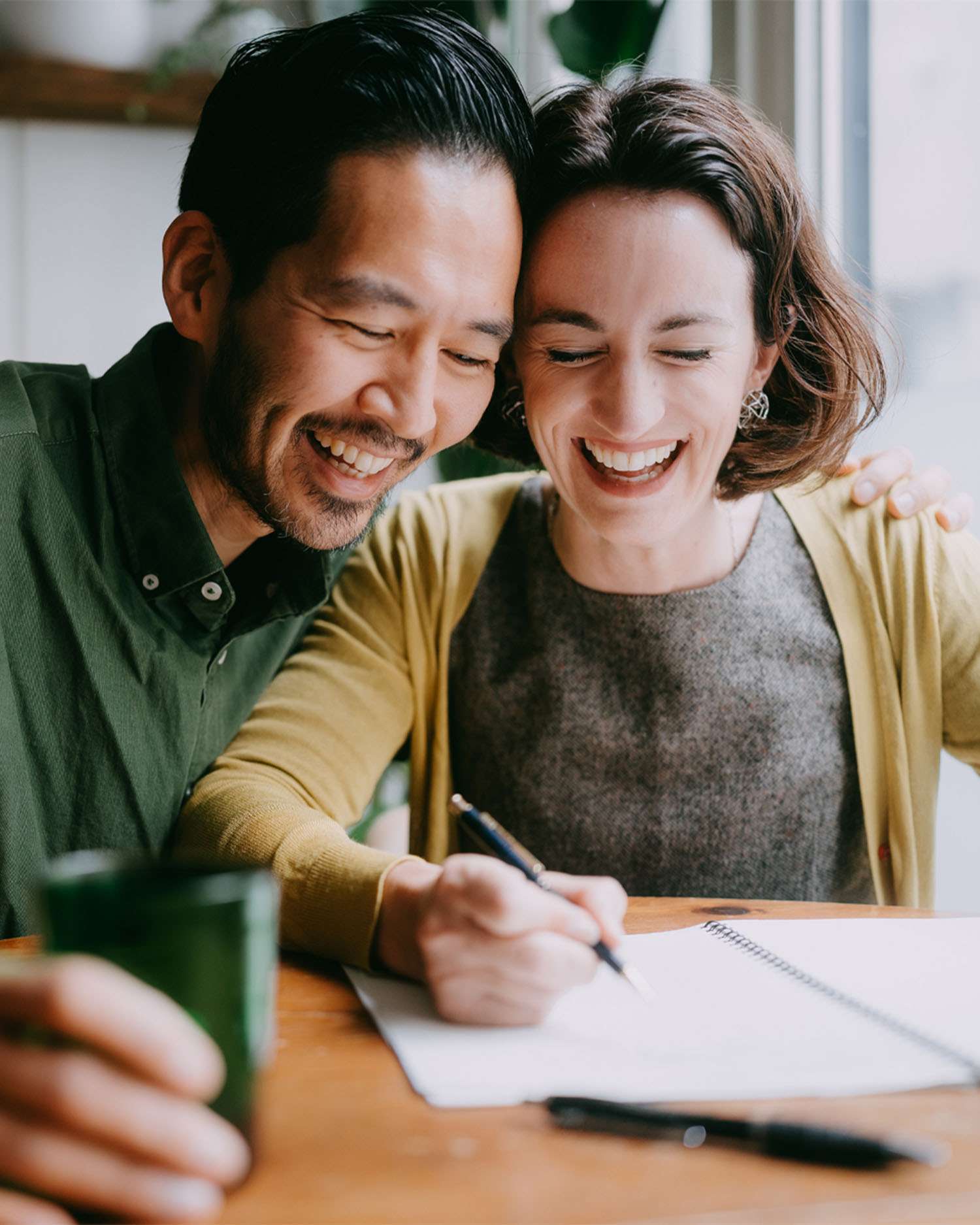 a couple doing finances happily