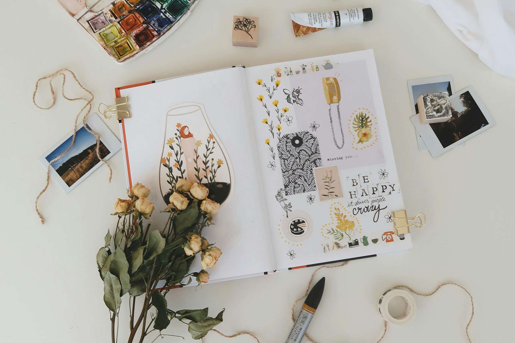 a display of flowers and craft pieces over a scrap book