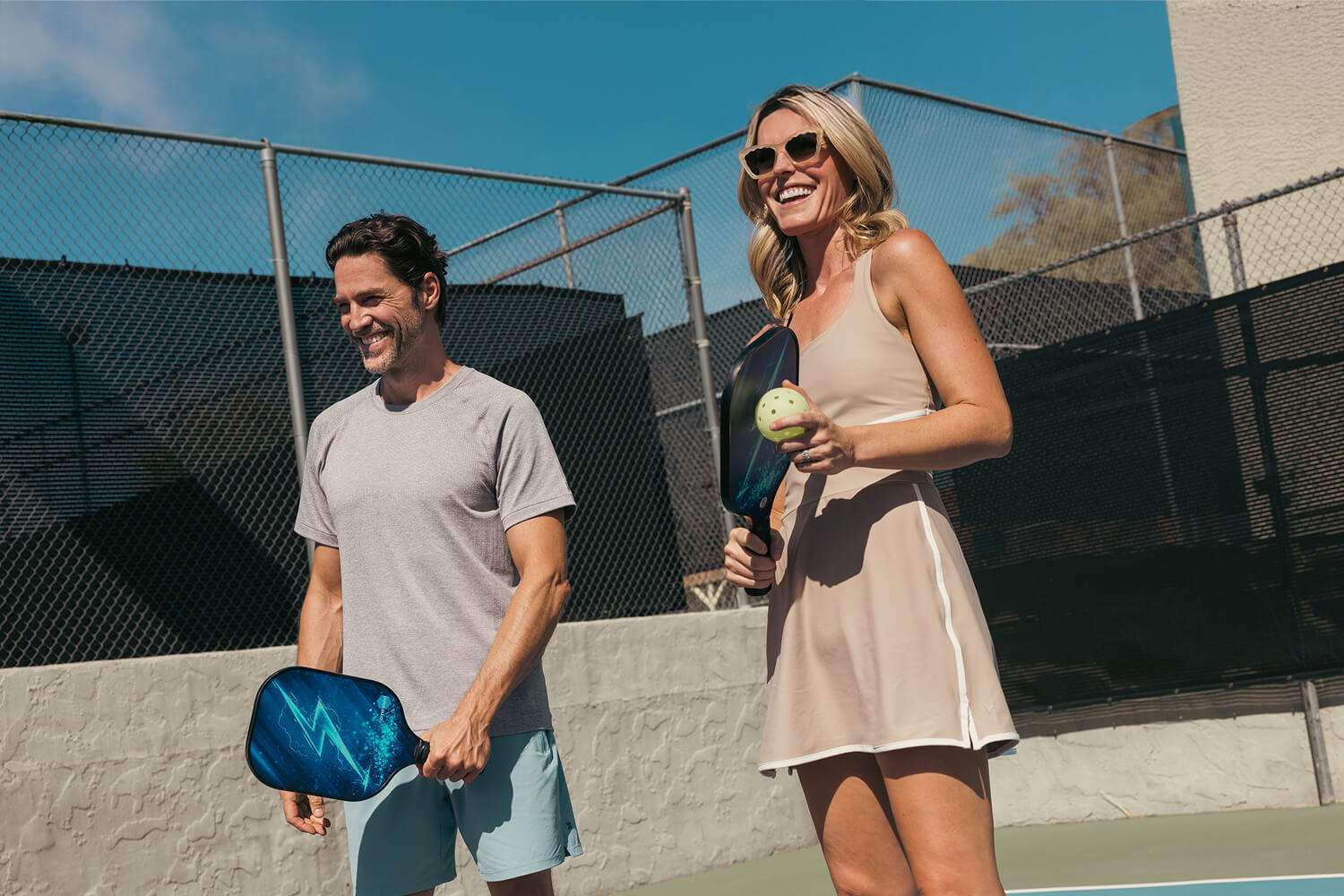 A man and woman playing pickleball