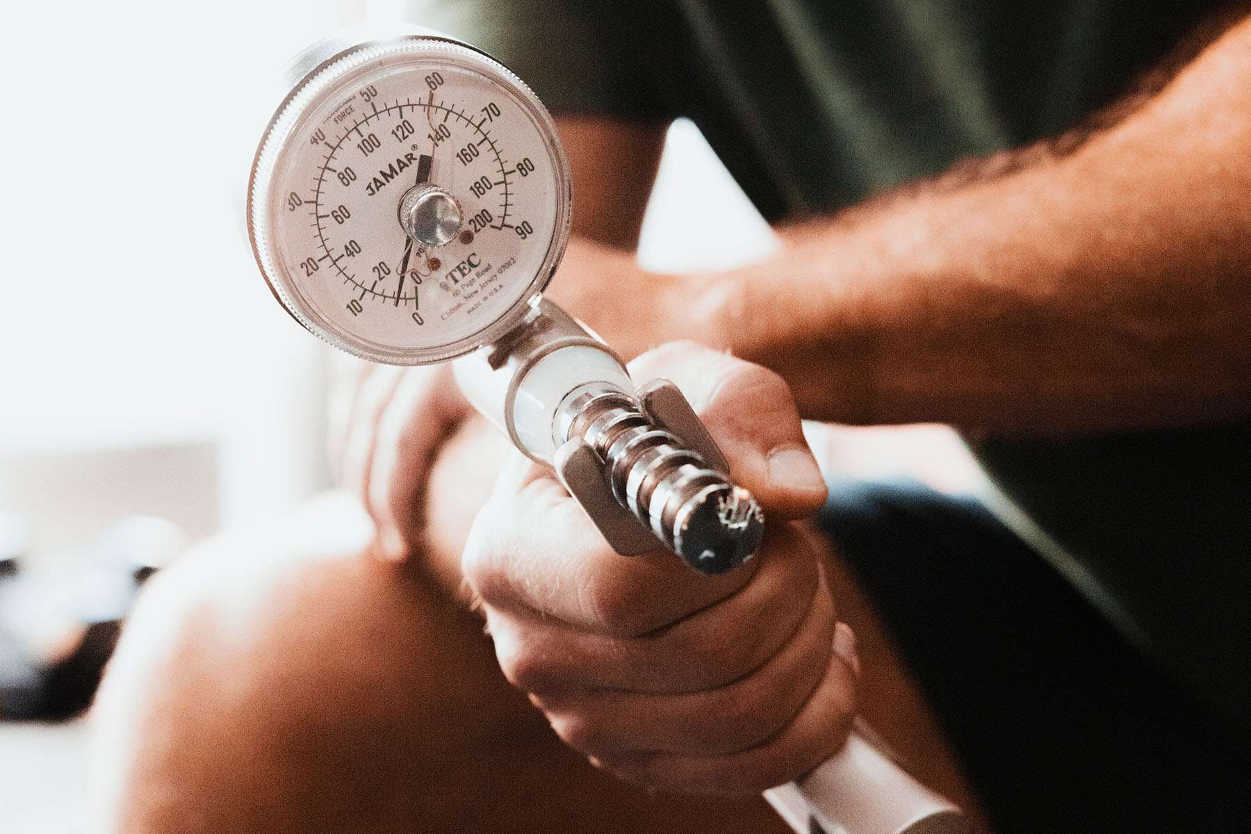 a man testing his grip strength on a machine