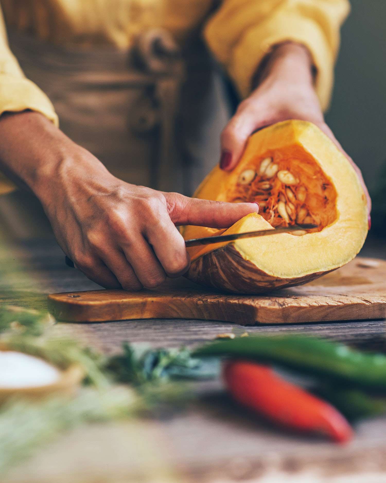 a woman cleaning seed out of ingredients