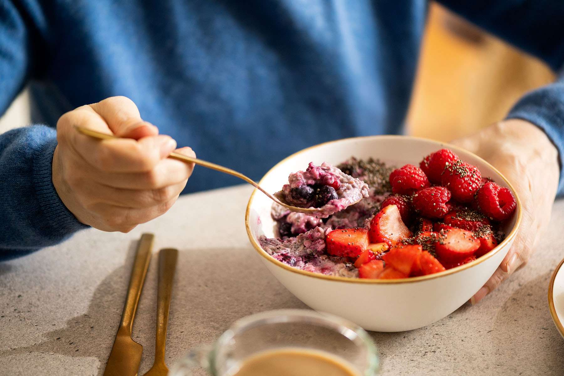 a person eating fruit from a bowl