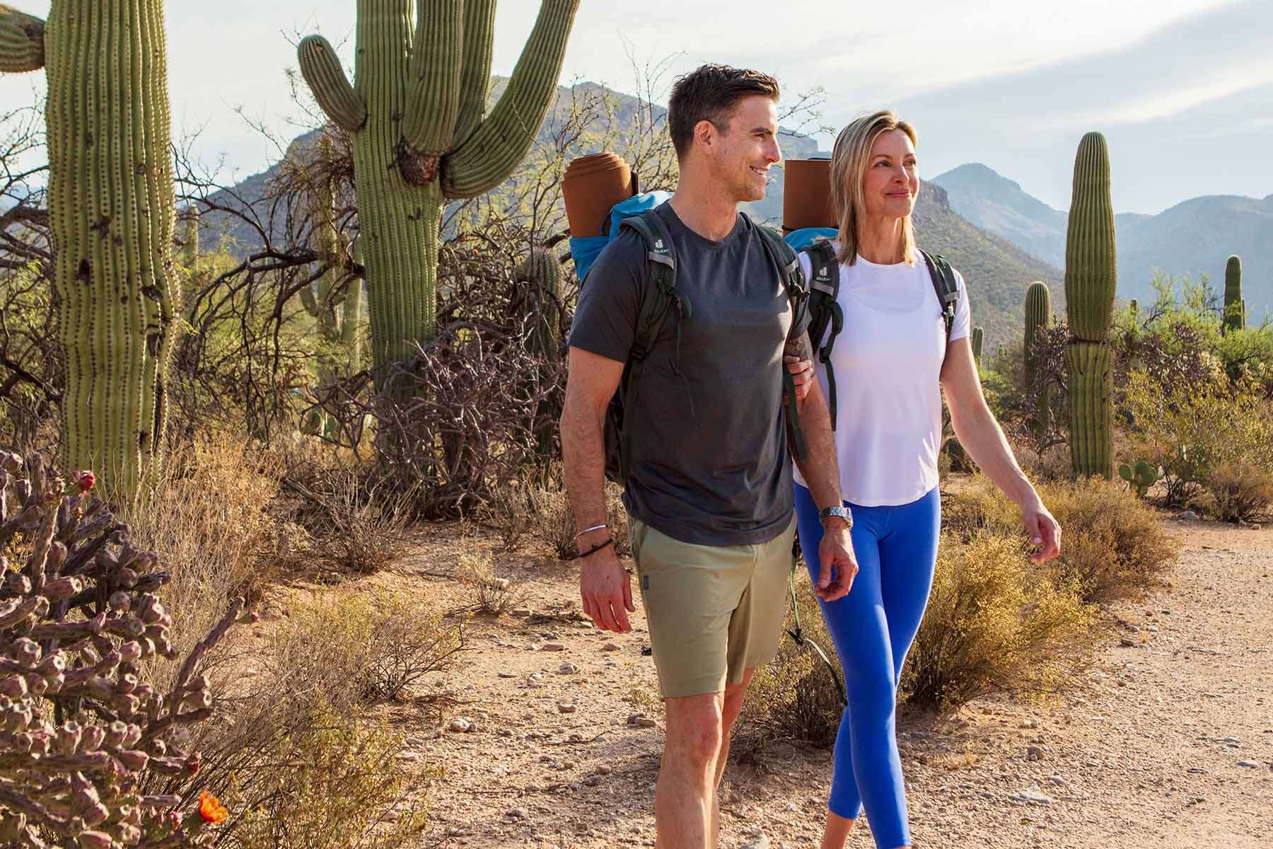 a couple walking through the Sonoran Desert