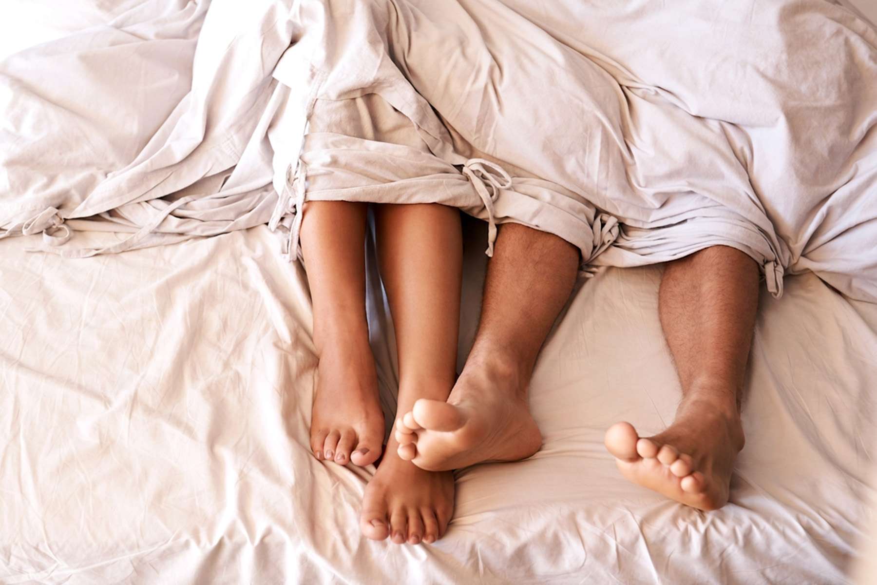a pair of legs poking out of a blanket