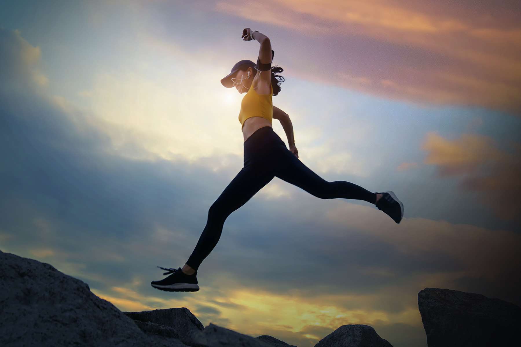 Woman Running and Jumping Over Rocks