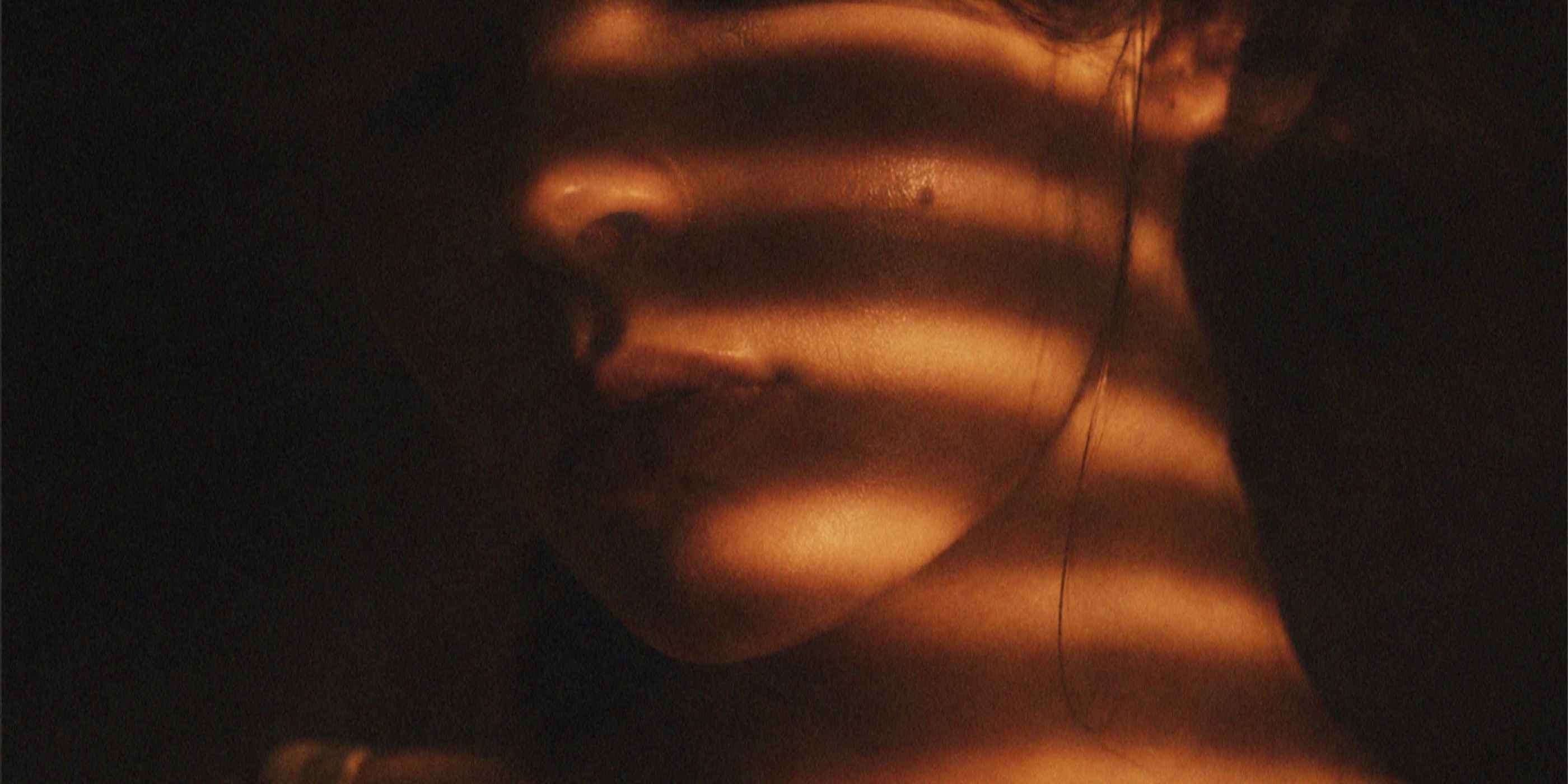 A close up image of a woman in shadows
