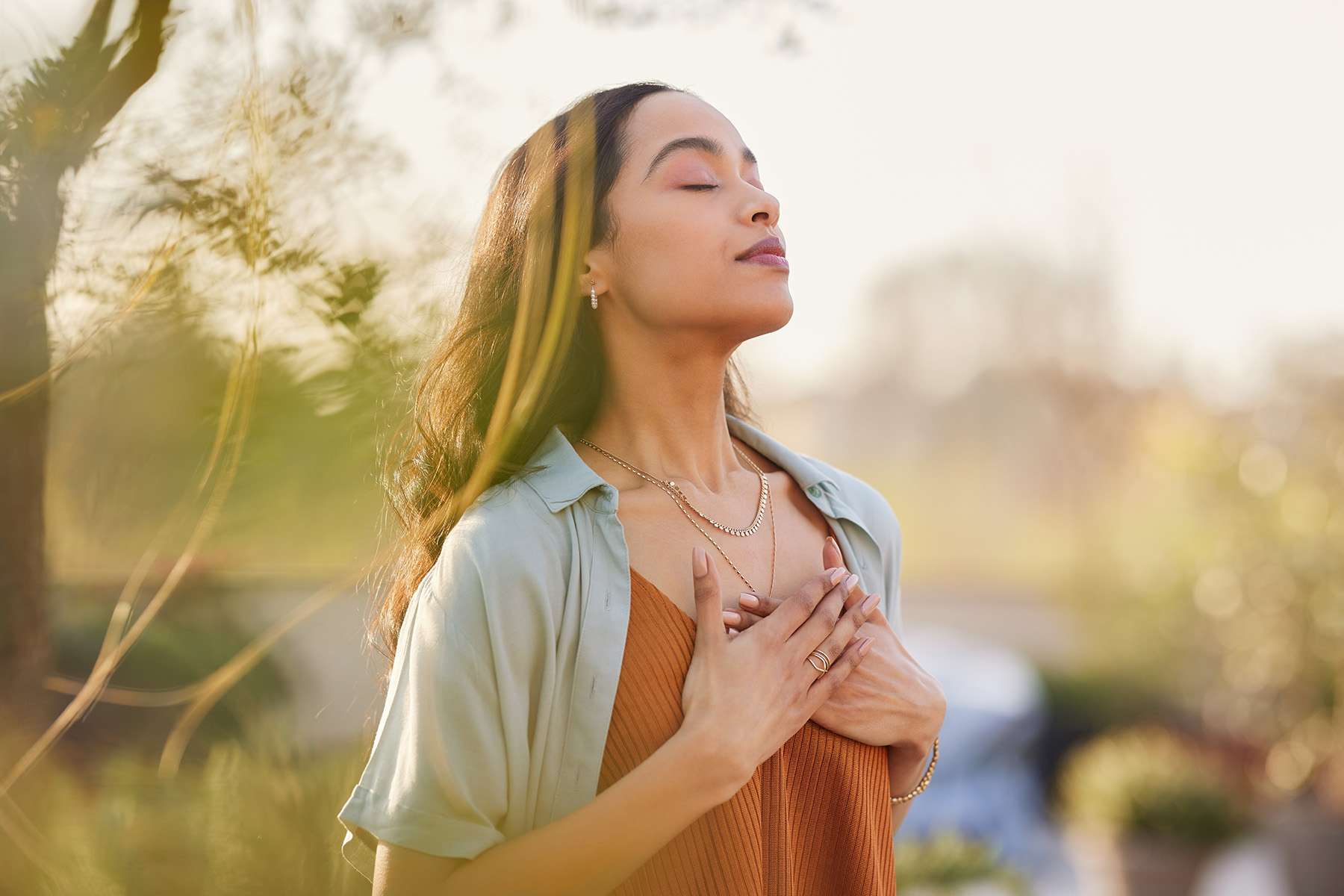 Woman With Eyes Closed Meditating in Nature 