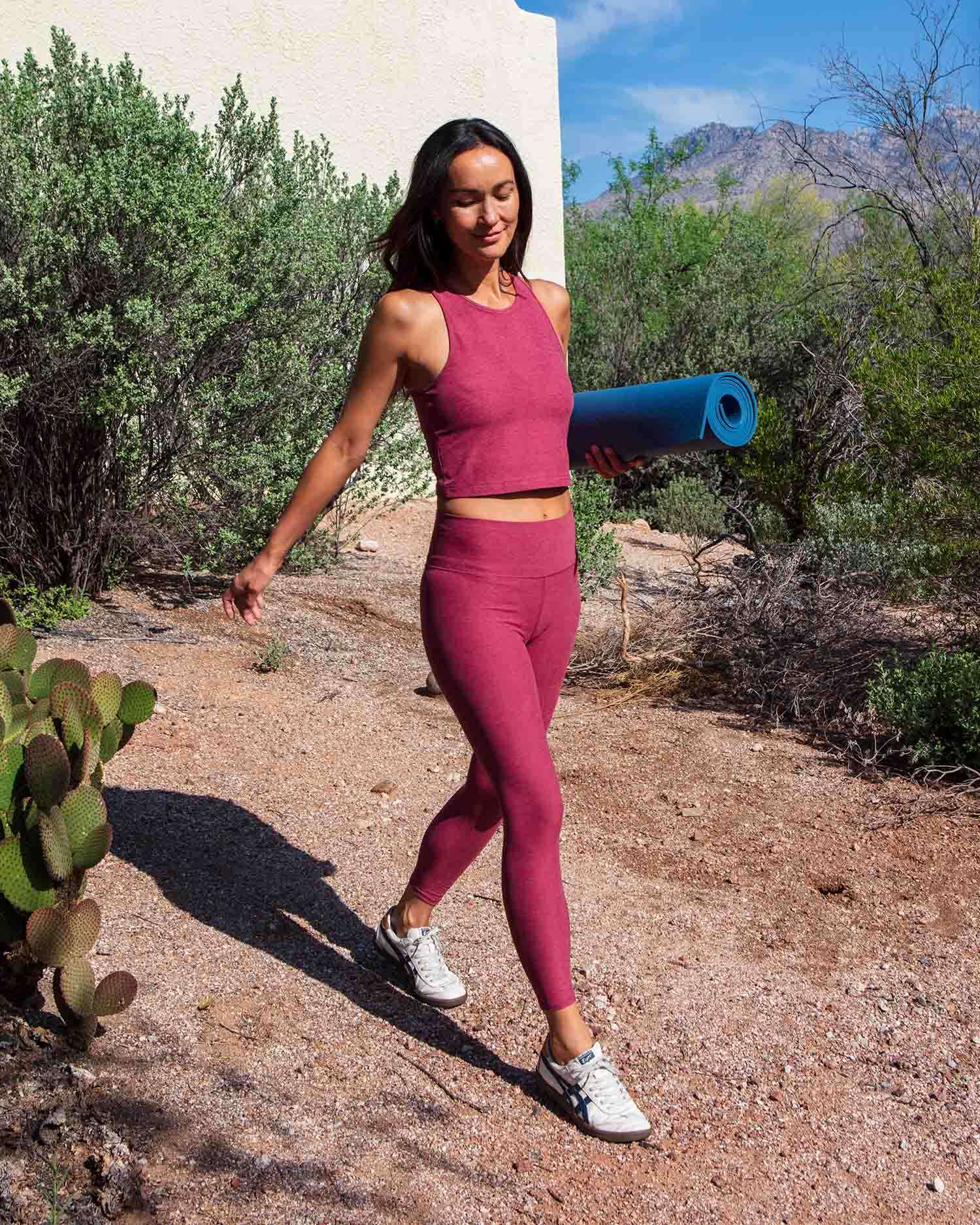 Woman Walking To A Yoga Class With Yoga Mat