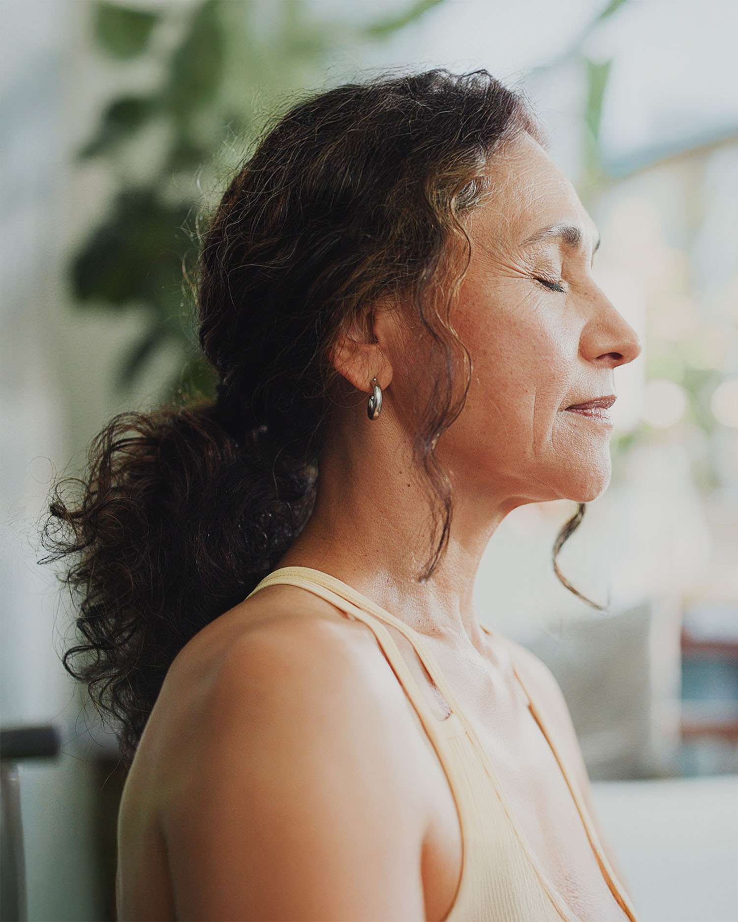 Woman Meditating in Front of a Window 