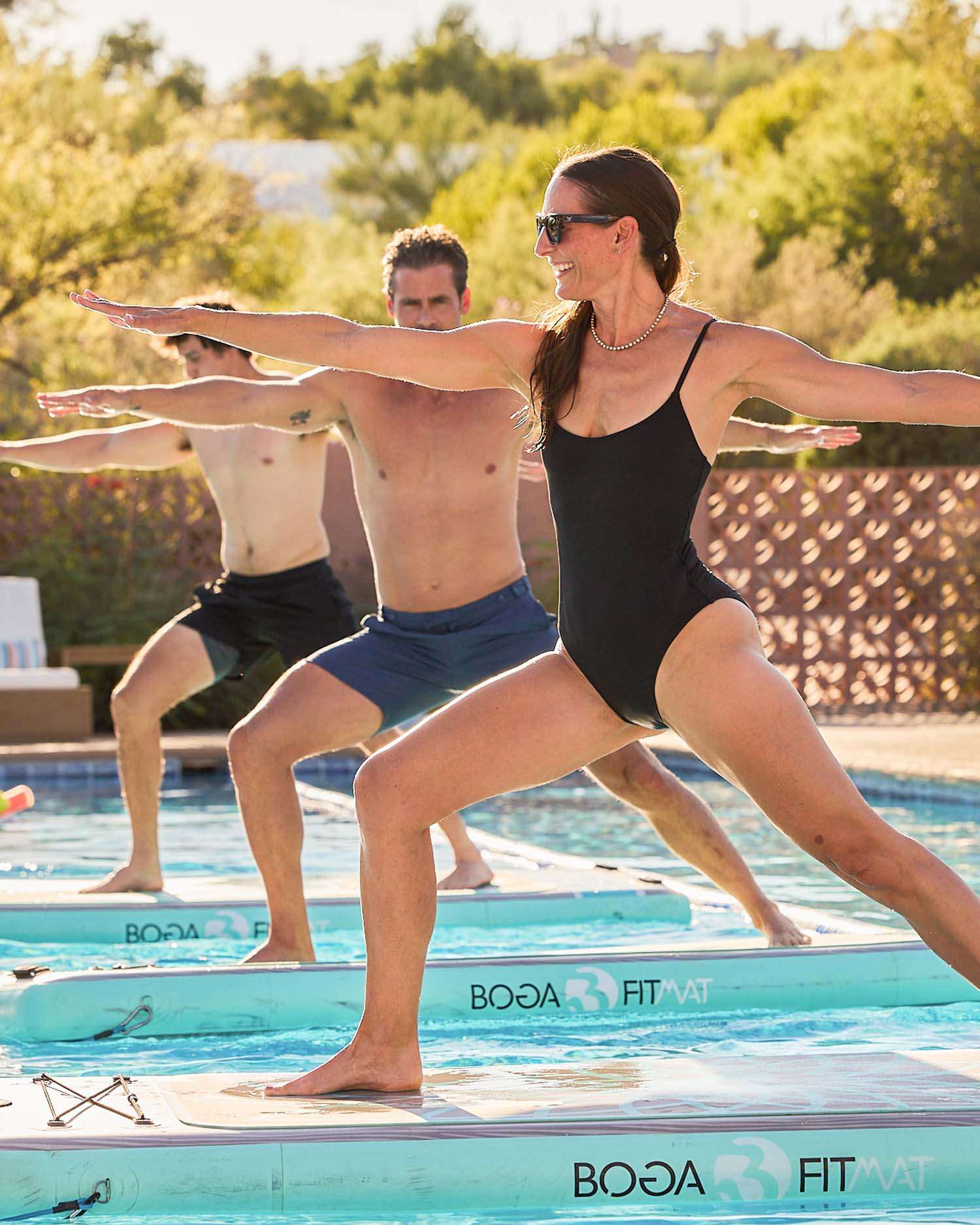 A Group Performing Yoga on a BOGA Fit Mat on Water