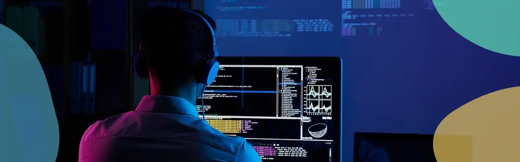 A man working on a computer in a dark room