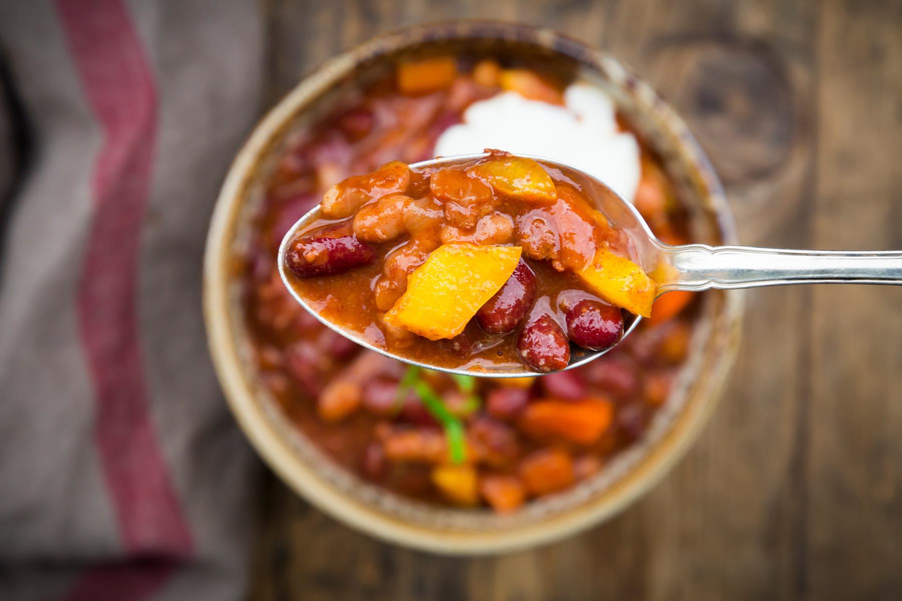 Overhead view of spoonful of vegetarian bean chili.