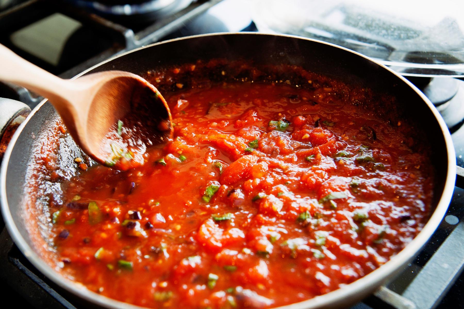 Close-up of pan filled with alla checca sauce.