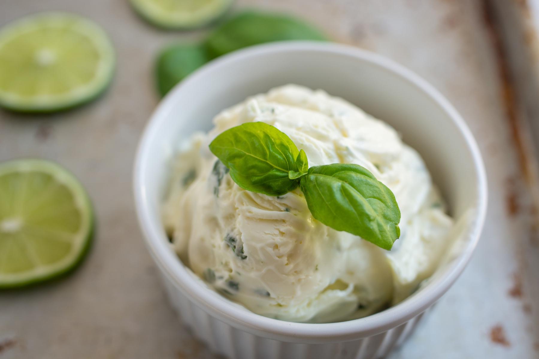 Small dish of lemon sorbet with basil garnish on top.