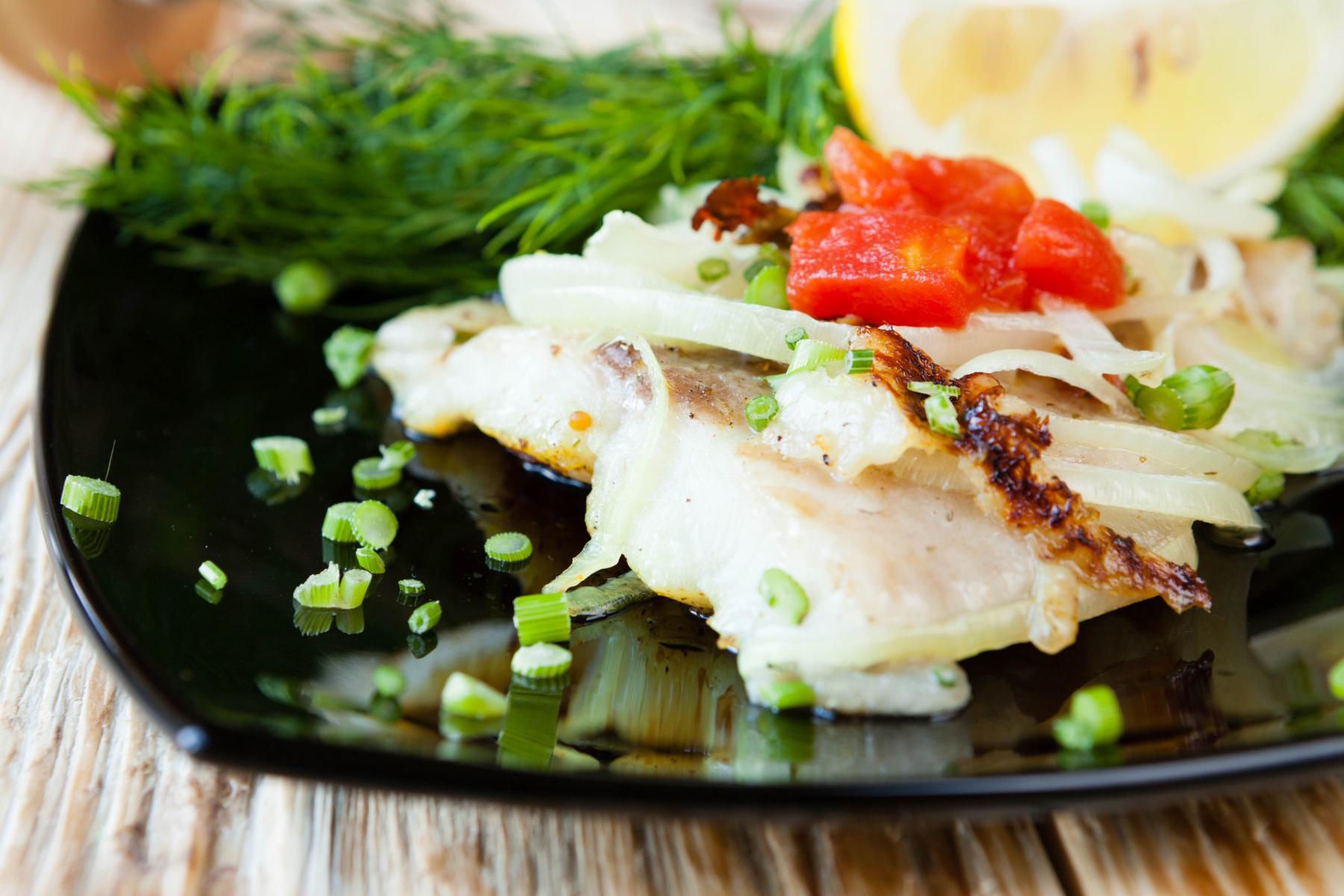 Close-up of a plate with sole and lemon grass salad.